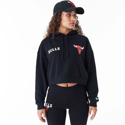 The Female model is wearing Chicago Bulls Womens NBA Team Logo Black Crop Pullover Hoodie 7