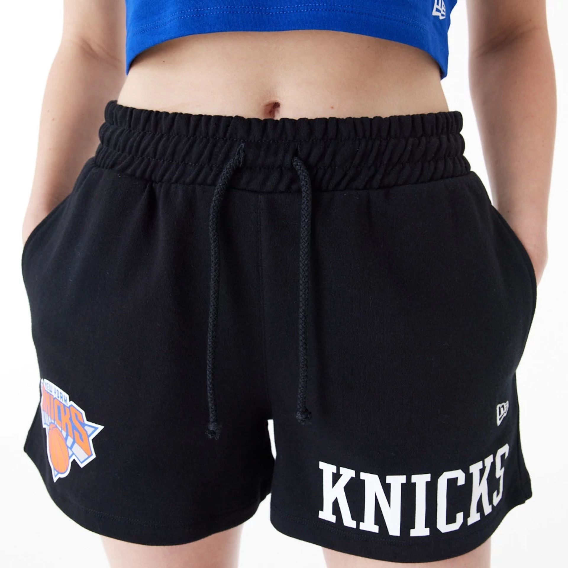 The Female model is wearing New York Knicks Womens NBA Team Logo Black Shorts 7