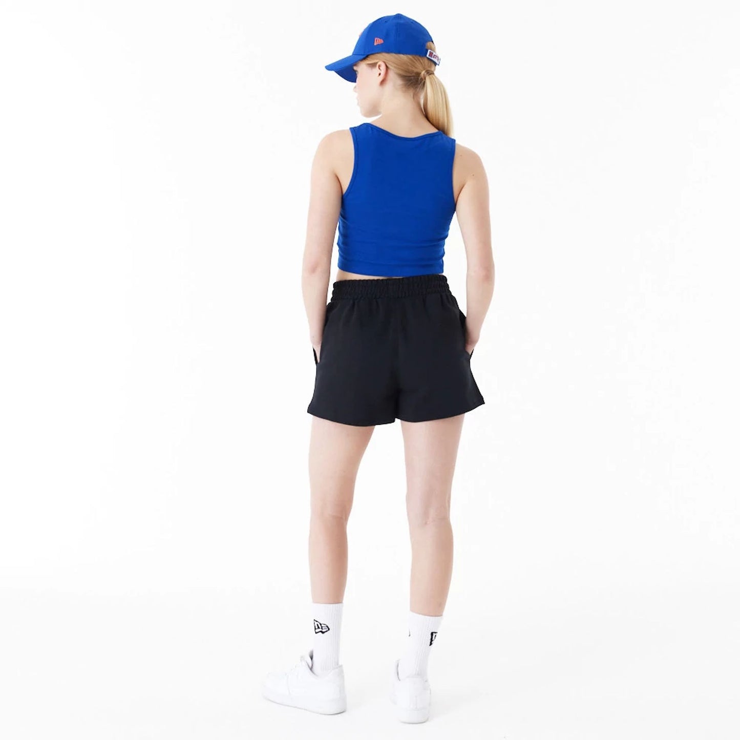 The Female model is wearing New York Knicks Womens NBA Team Logo Black Shorts 4