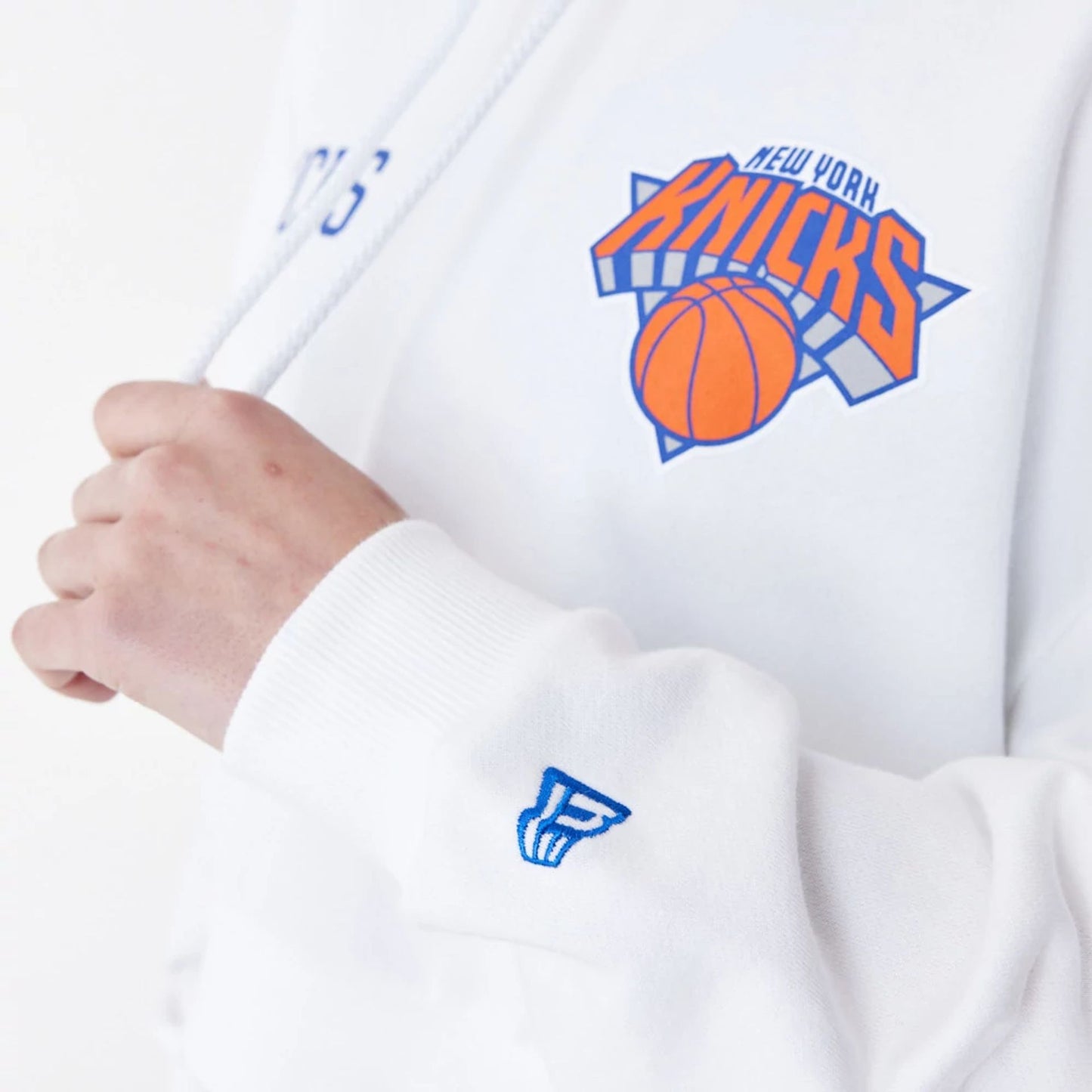 The Female model is wearing New York Knicks Womens NBA Team Logo White Crop Pullover Hoodie 9