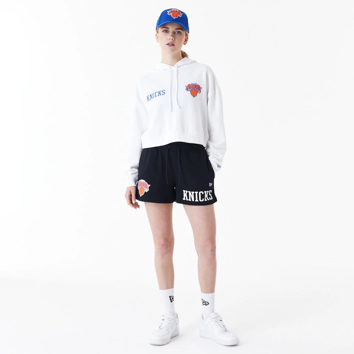 The Female model is wearing New York Knicks Womens NBA Team Logo White Crop Pullover Hoodie 3