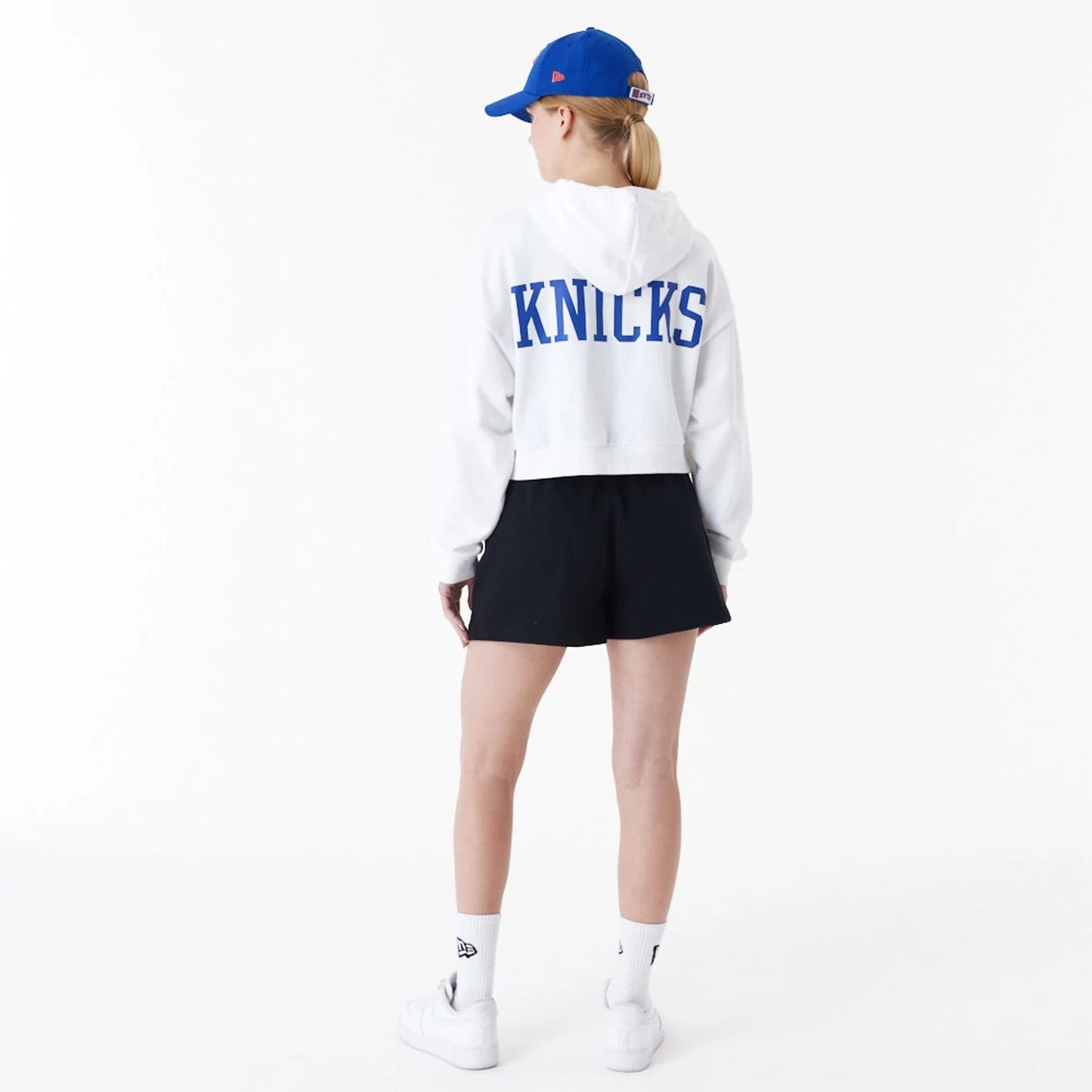 The Female model is wearing New York Knicks Womens NBA Team Logo White Crop Pullover Hoodie 4