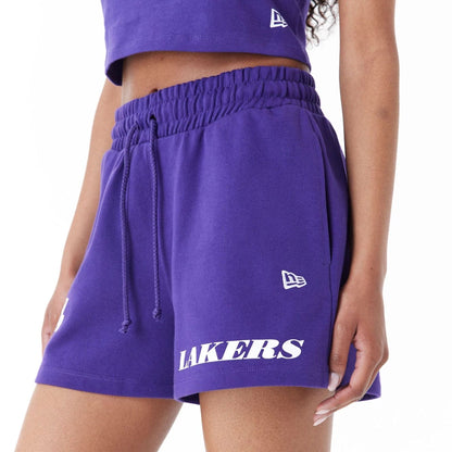 The Female model is wearing LA Lakers Womens NBA Team Logo Purple Shorts 3