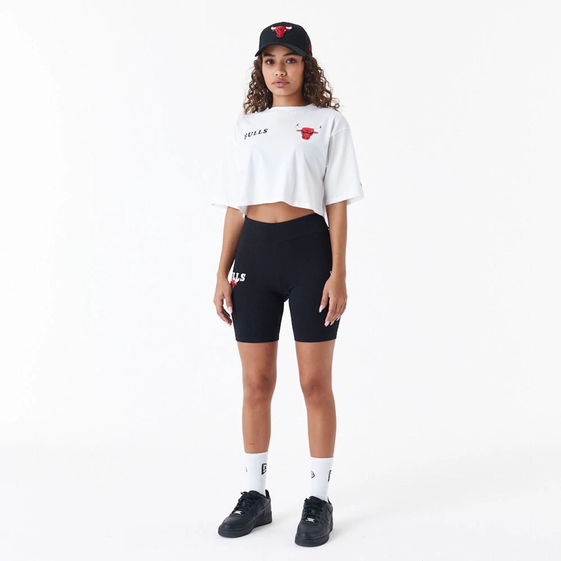 The Female model is wearing Chicago Bulls Womens NBA Team Logo White Crop T-Shirt 5