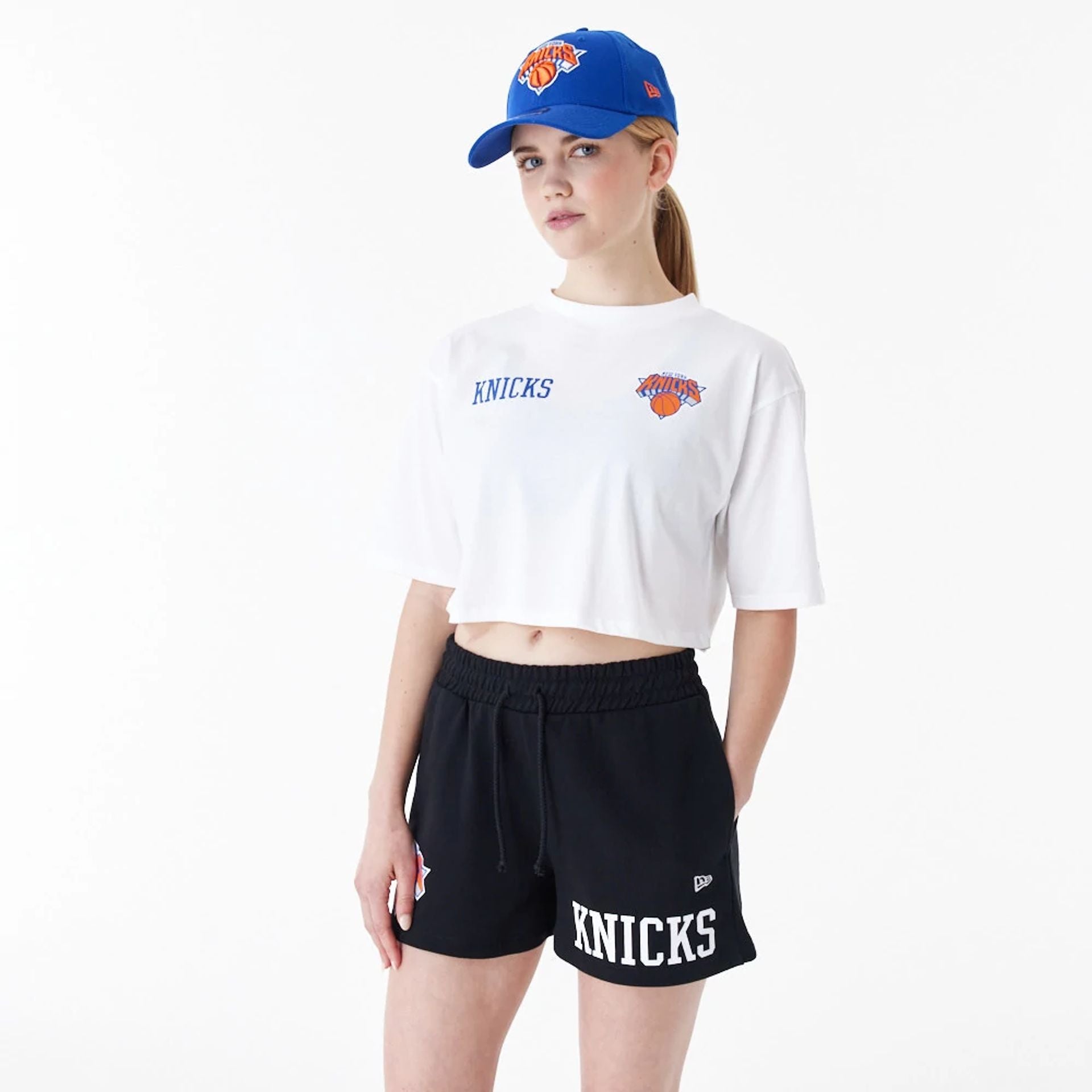 The Female model is wearing New York Knicks Womens NBA Team Logo White Crop T-Shirt 1