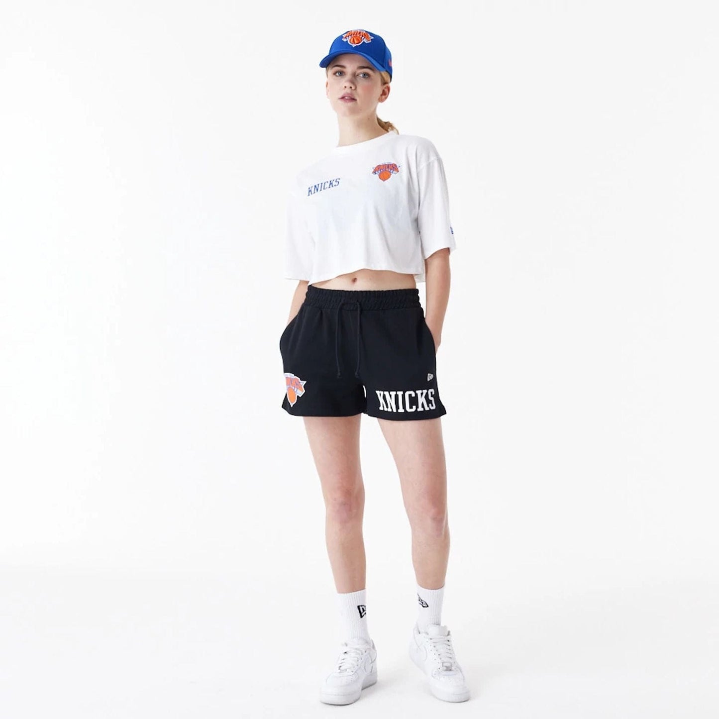 The Female model is wearing New York Knicks Womens NBA Team Logo White Crop T-Shirt 8