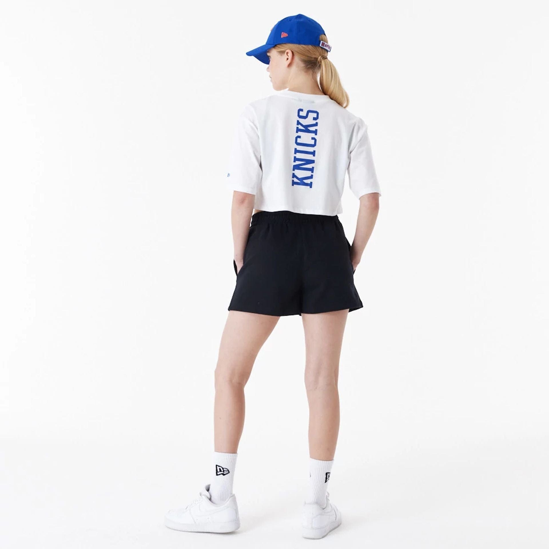 The Female model is wearing New York Knicks Womens NBA Team Logo White Crop T-Shirt 3