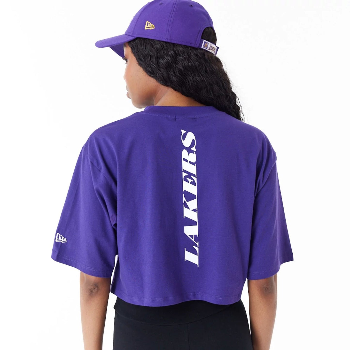 The Female model is wearing LA Lakers Womens NBA Team Logo Purple Crop T-Shirt 4