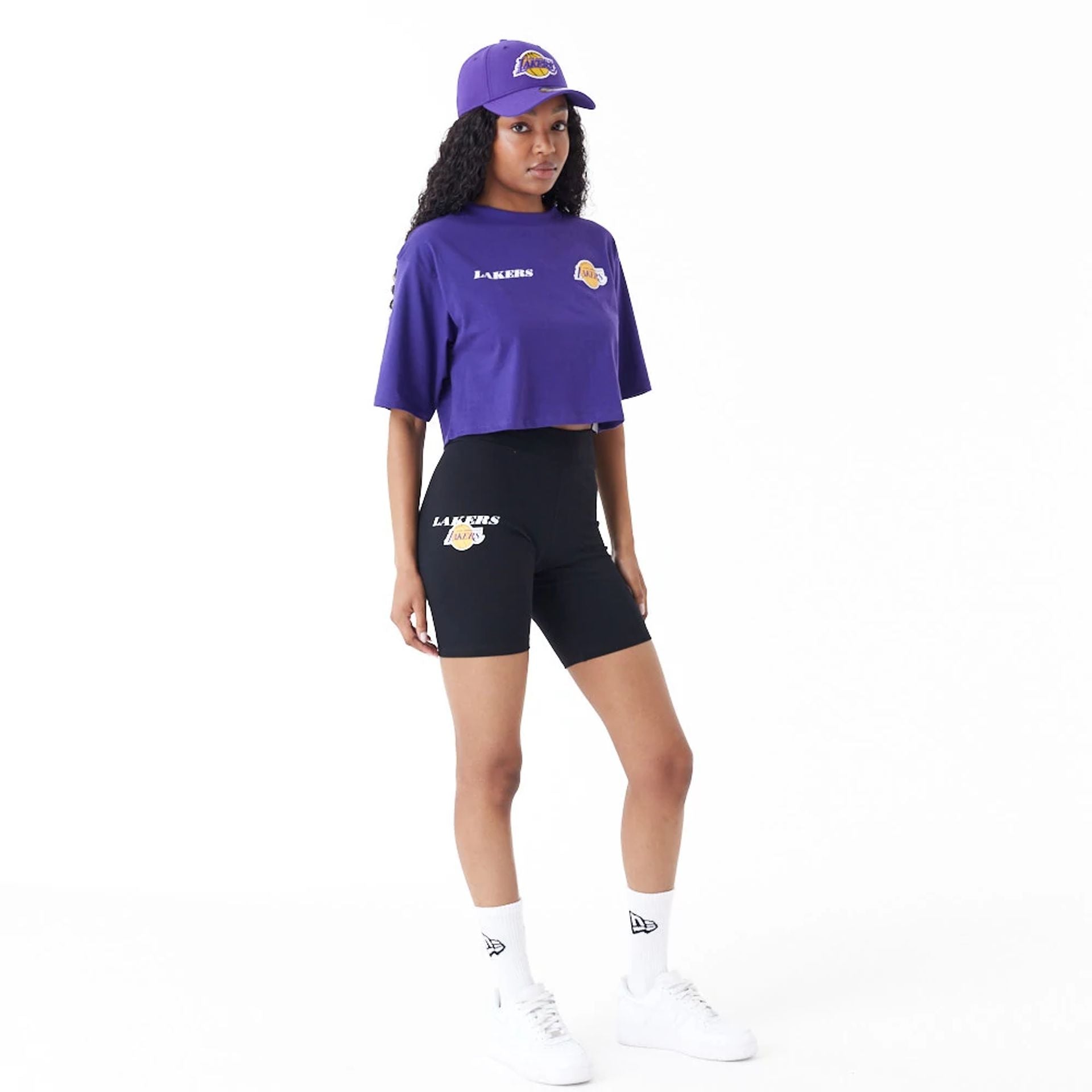 The Female model is wearing LA Lakers Womens NBA Team Logo Purple Crop T-Shirt 2