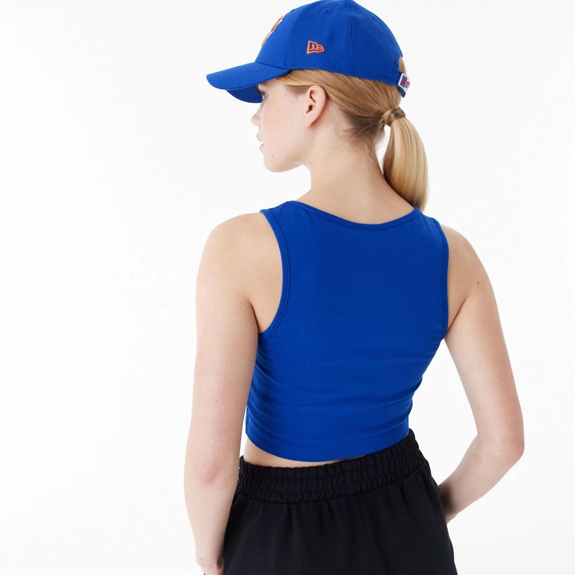 The Female model is wearing New York Knicks Womens NBA Team Logo Blue Crop Tank Top 5