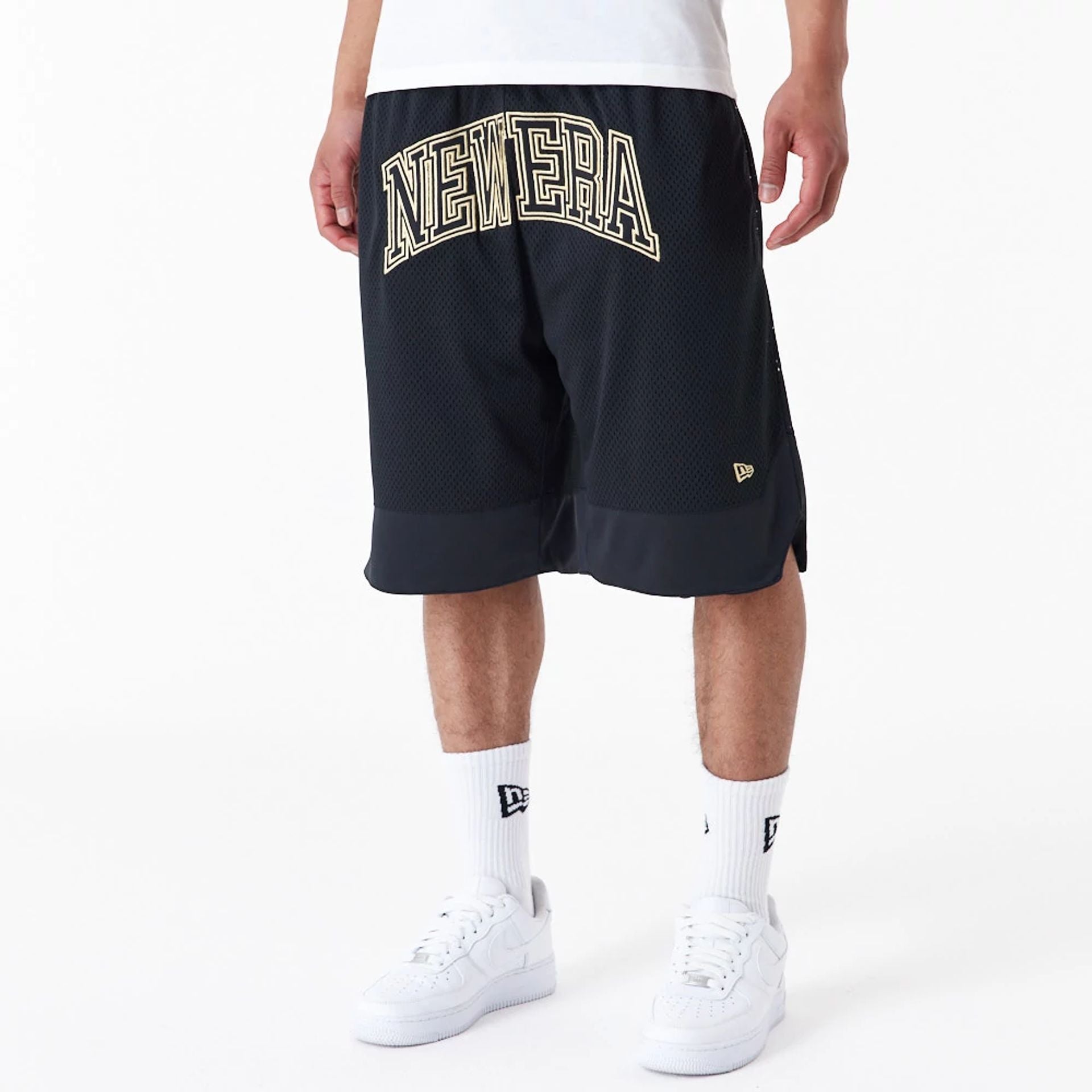 The Male model is wearing New Era Black Oversized Mesh Shorts 2