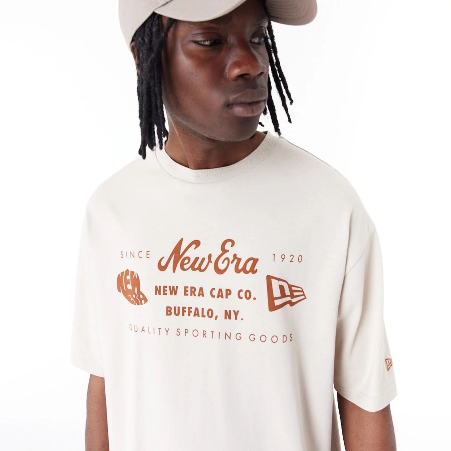 The Male model is wearing New Era Heritage Patch Stone Oversized T-Shirt 4