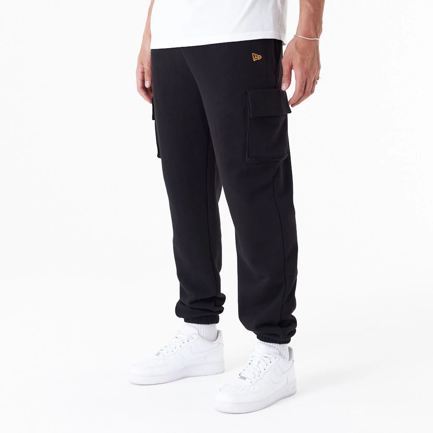 The Male model is wearing New Era Script Black Cargo Joggers 4