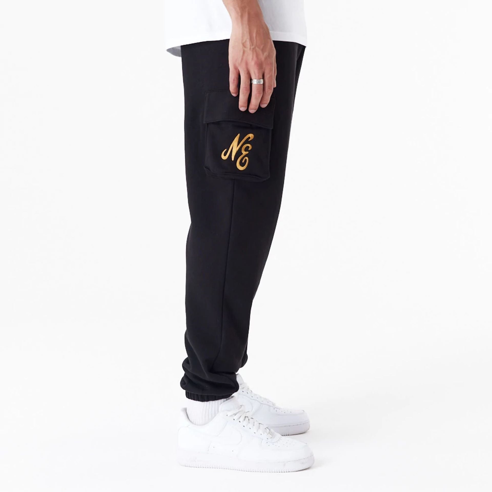 The Male model is wearing New Era Script Black Cargo Joggers 5