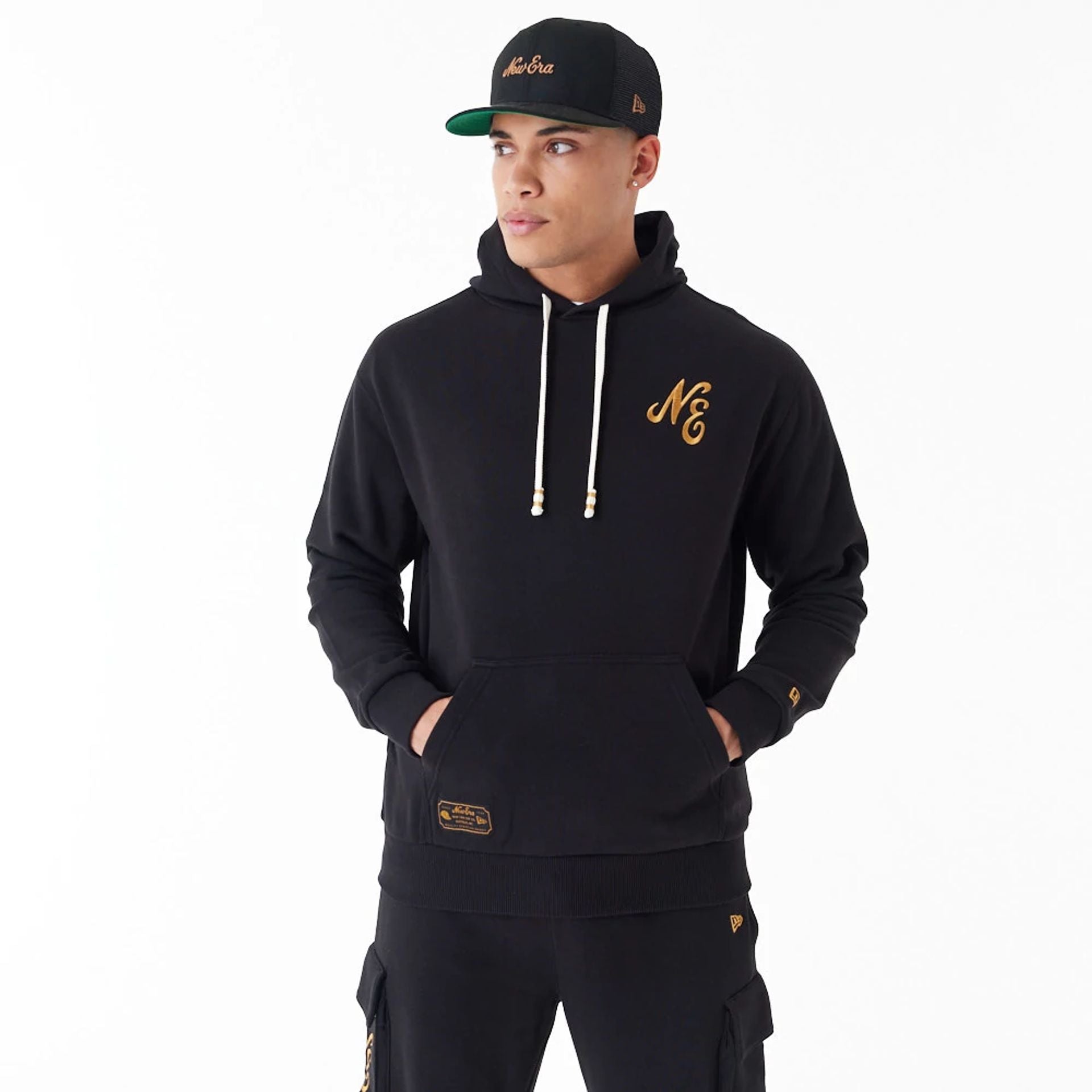 The Male model is wearing New Era Script Logo Black Oversized Pullover Hoodie 10