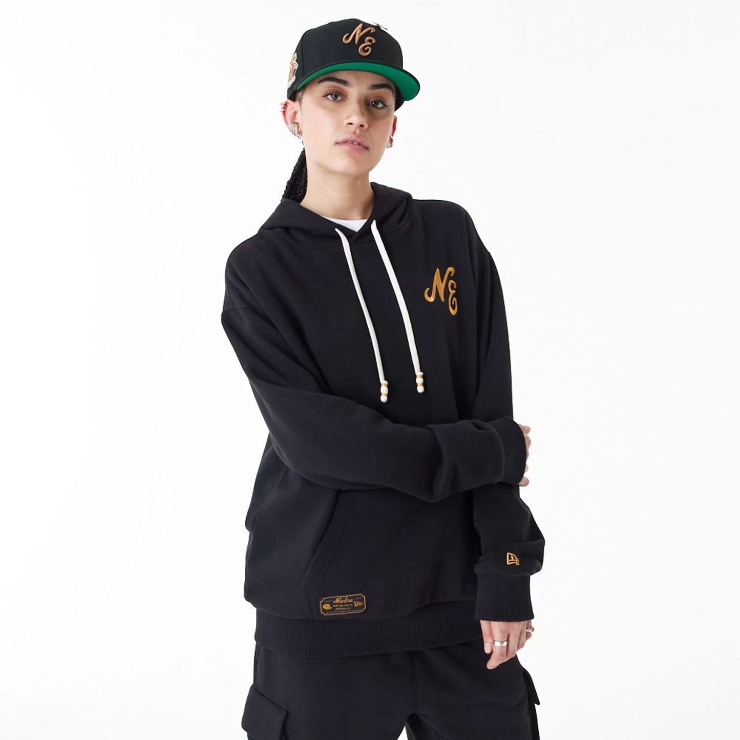 The Male model is wearing New Era Script Logo Black Oversized Pullover Hoodie 5