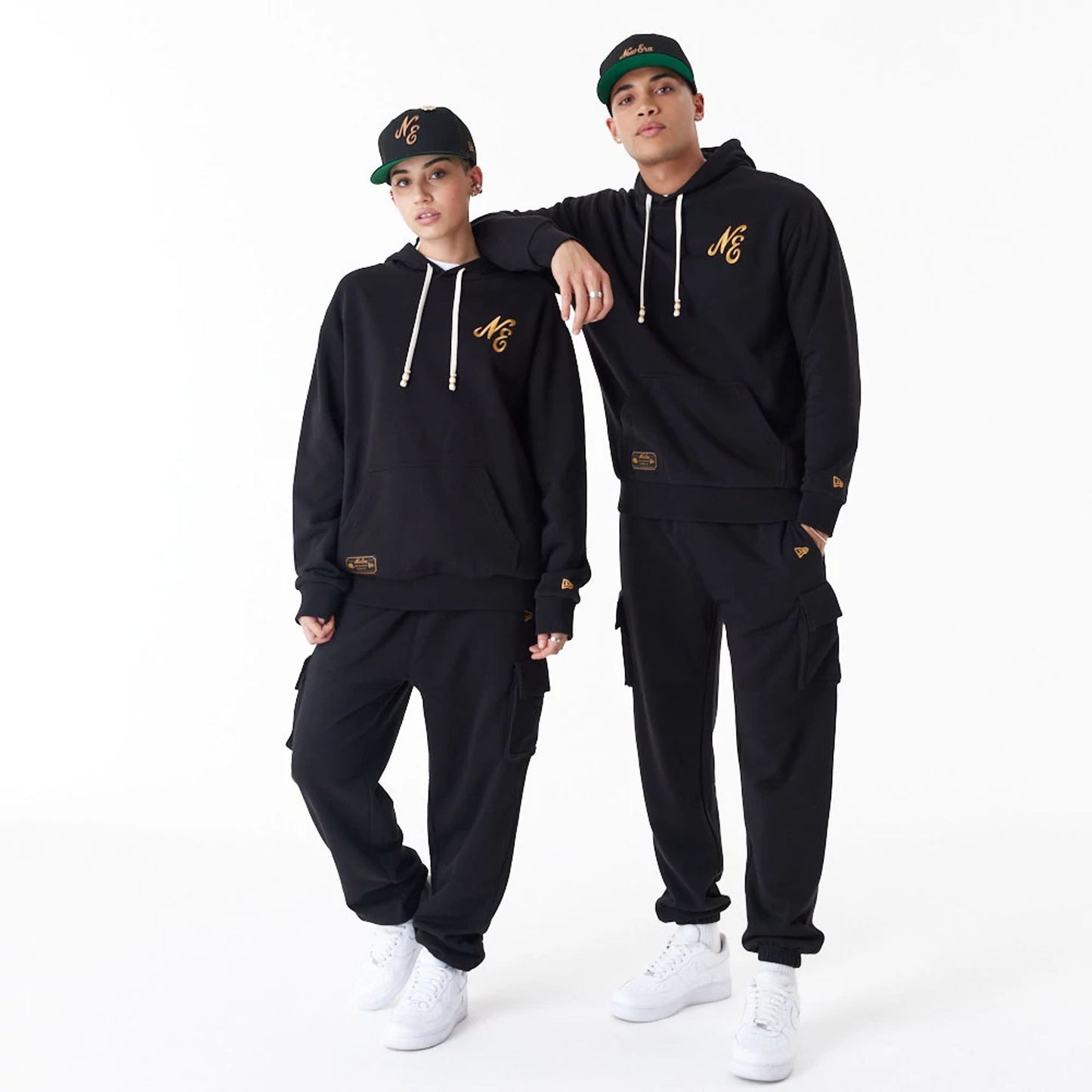 The Male model is wearing New Era Script Logo Black Oversized Pullover Hoodie 9