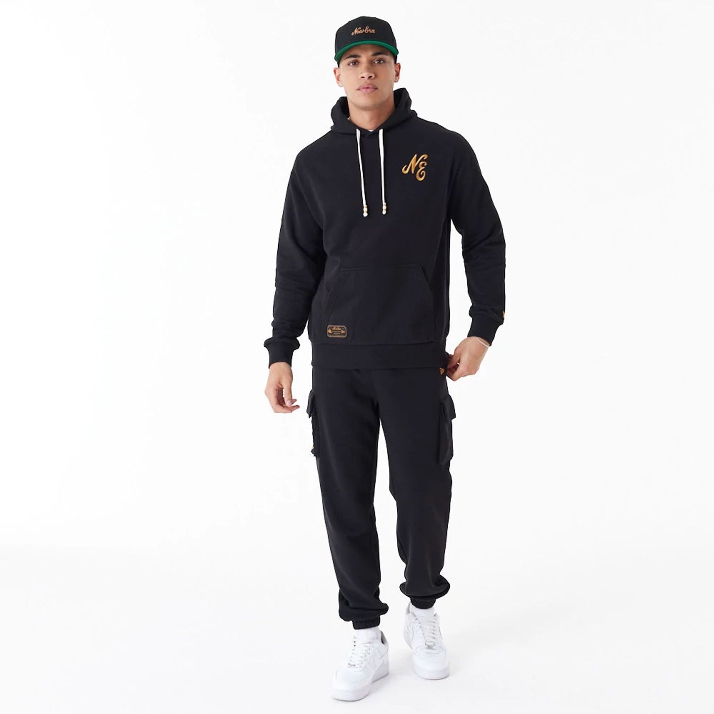 The Male model is wearing New Era Script Logo Black Oversized Pullover Hoodie 3