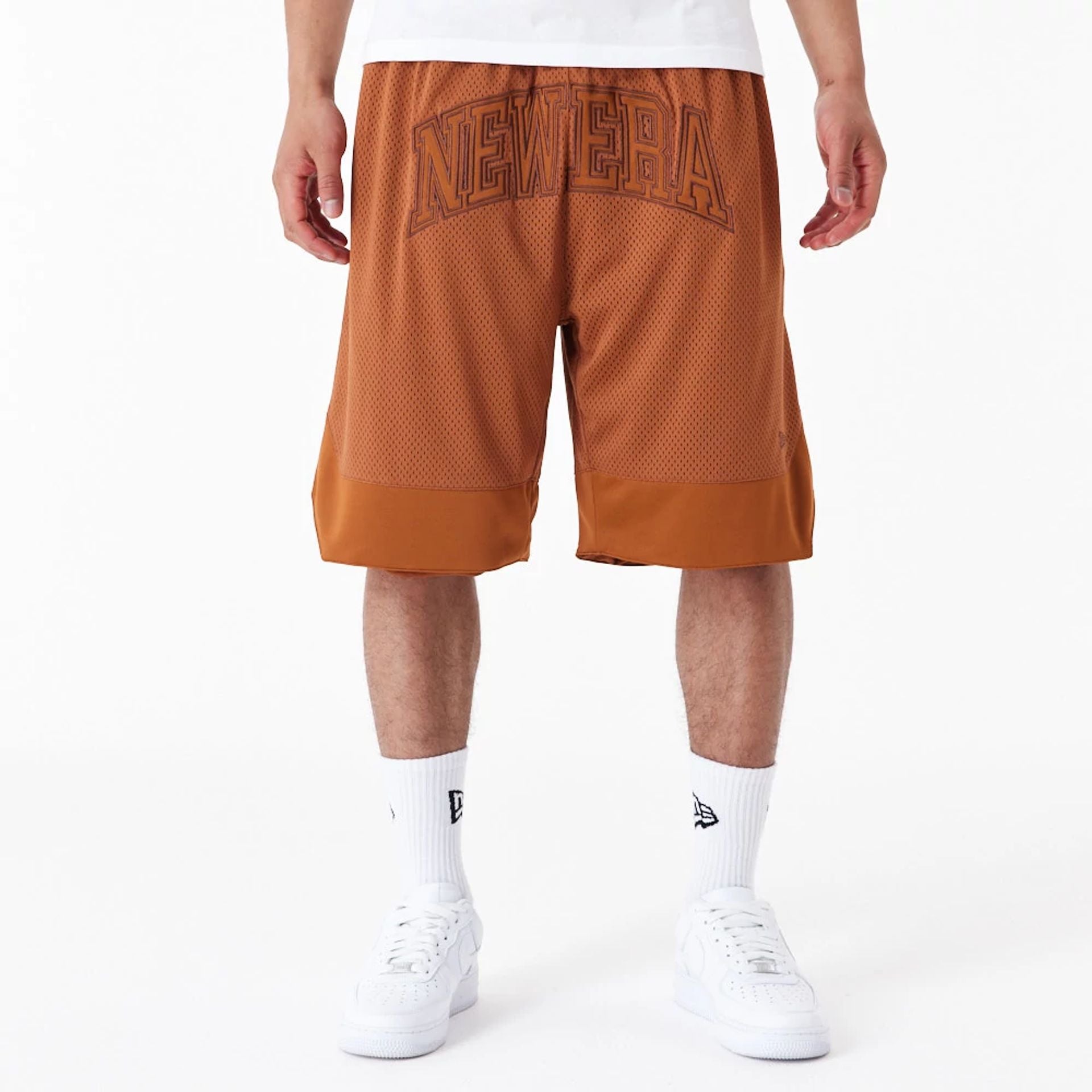 The Male model is wearing New Era Arch Logo Brown Mesh Shorts 1