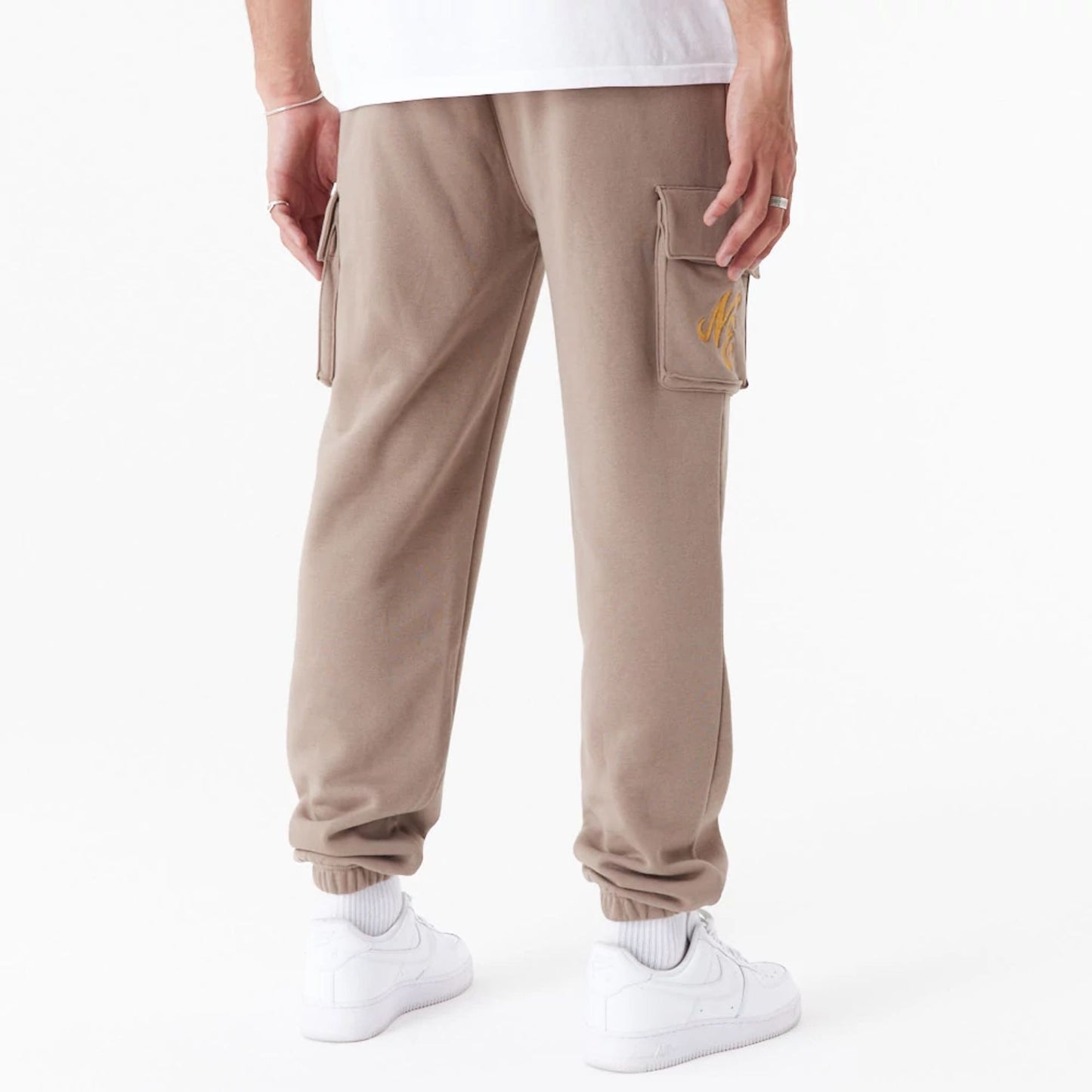 The Male model is wearing New Era Script Brown Cargo Joggers 4