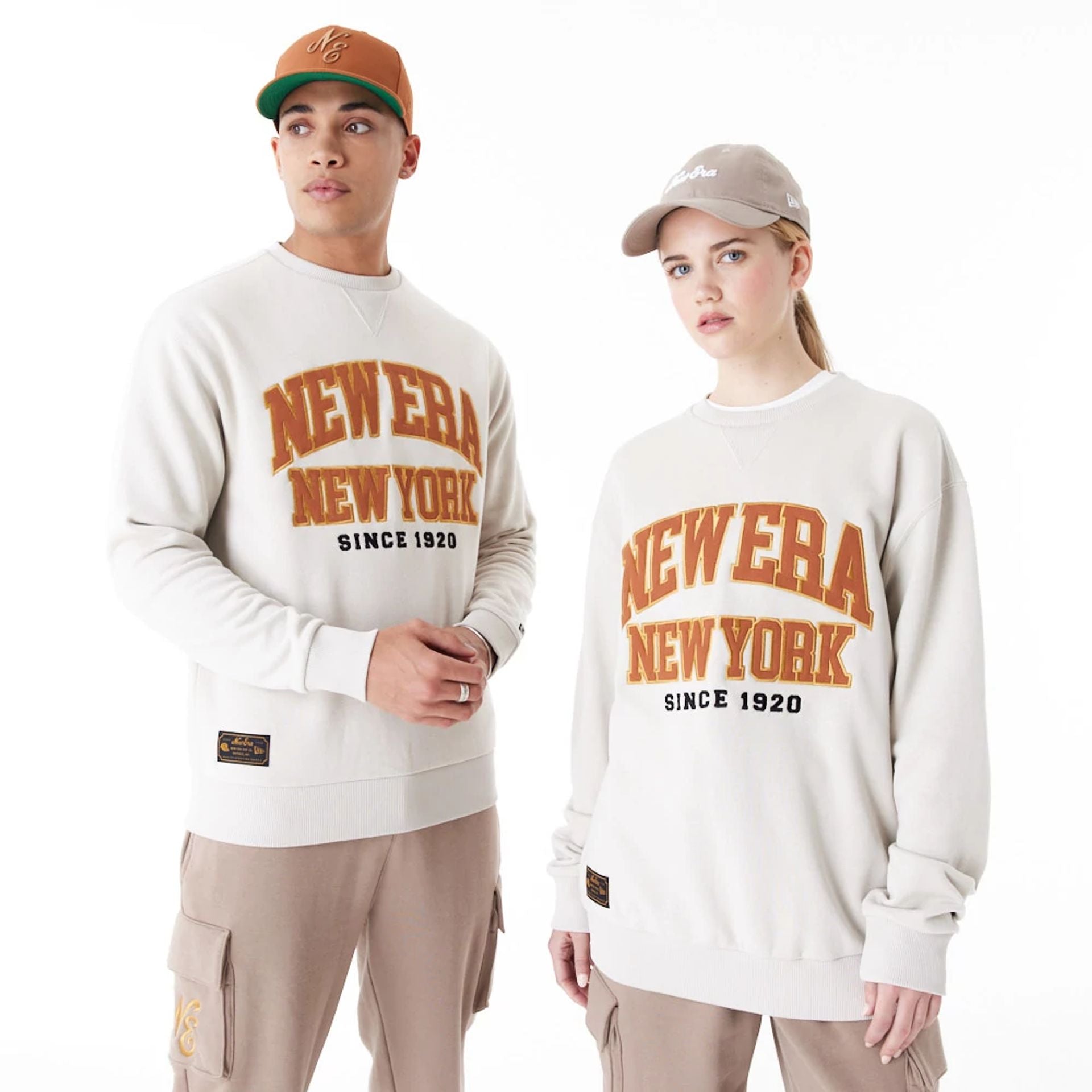 The Male model is wearing New Era Arch Graphic Stone Crew Neck Sweatshirt 1