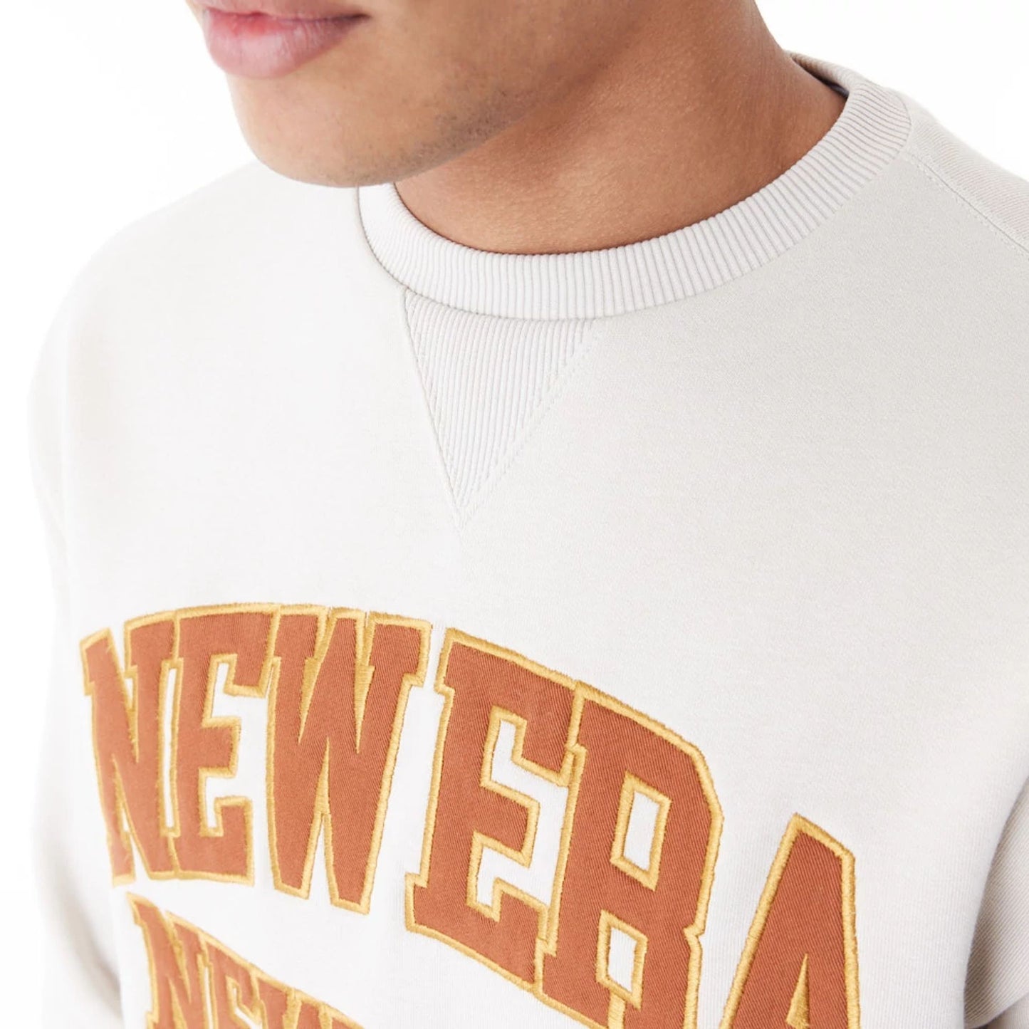 The Male model is wearing New Era Arch Graphic Stone Crew Neck Sweatshirt 3