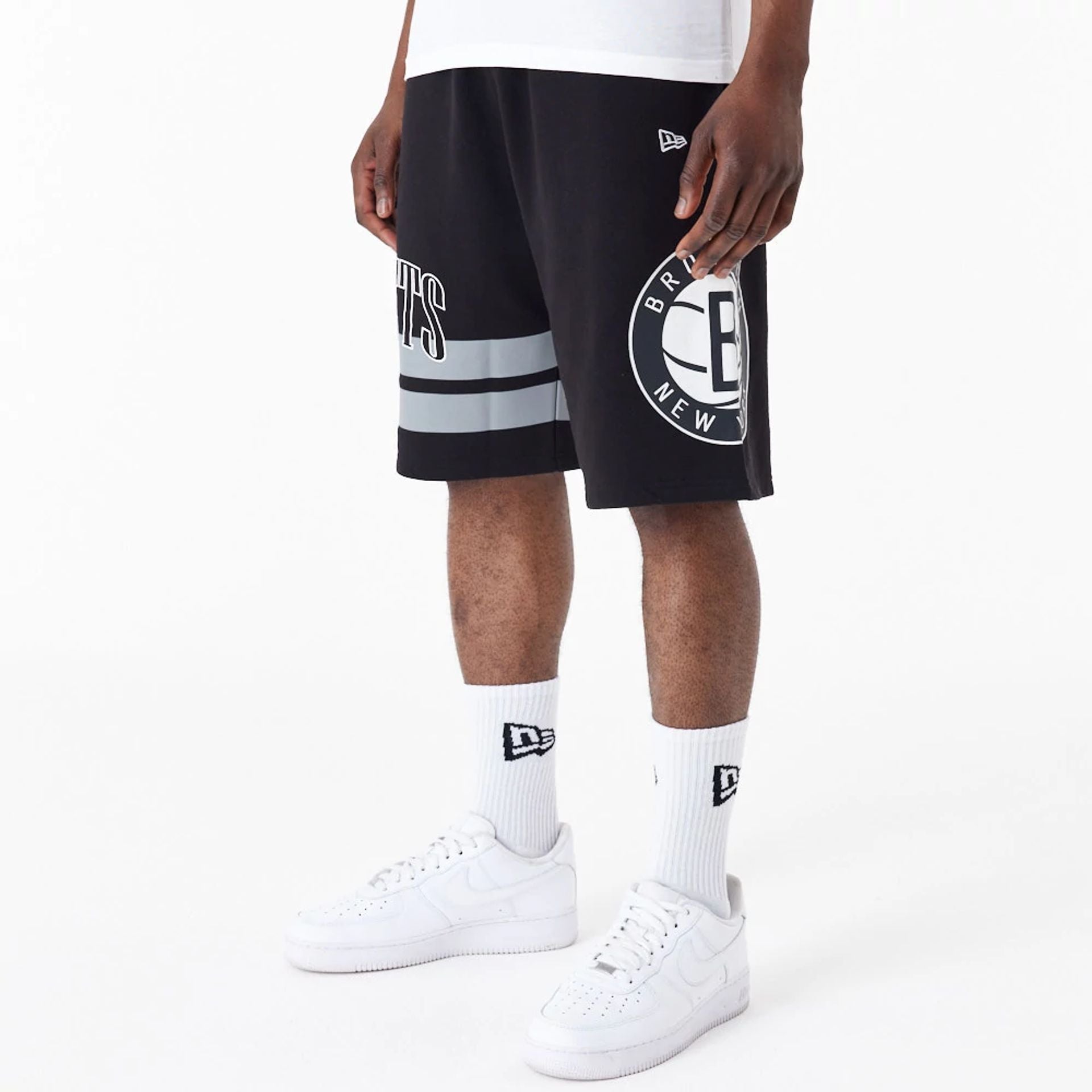 The Male model is wearing Brooklyn Nets NBA Arch Graphic Black Shorts 2