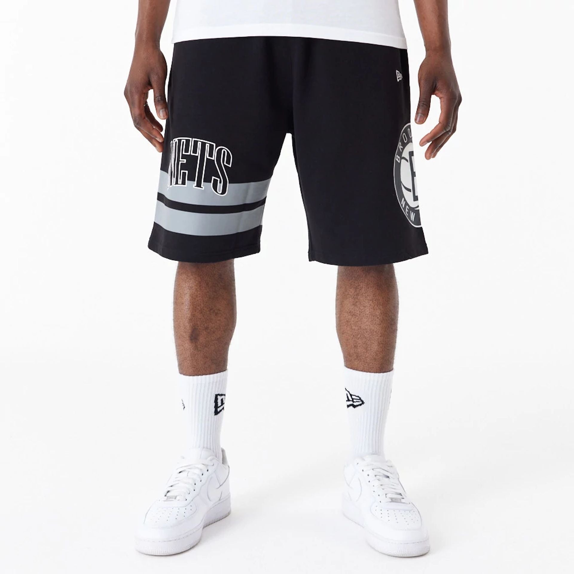 The Male model is wearing Brooklyn Nets NBA Arch Graphic Black Shorts 1