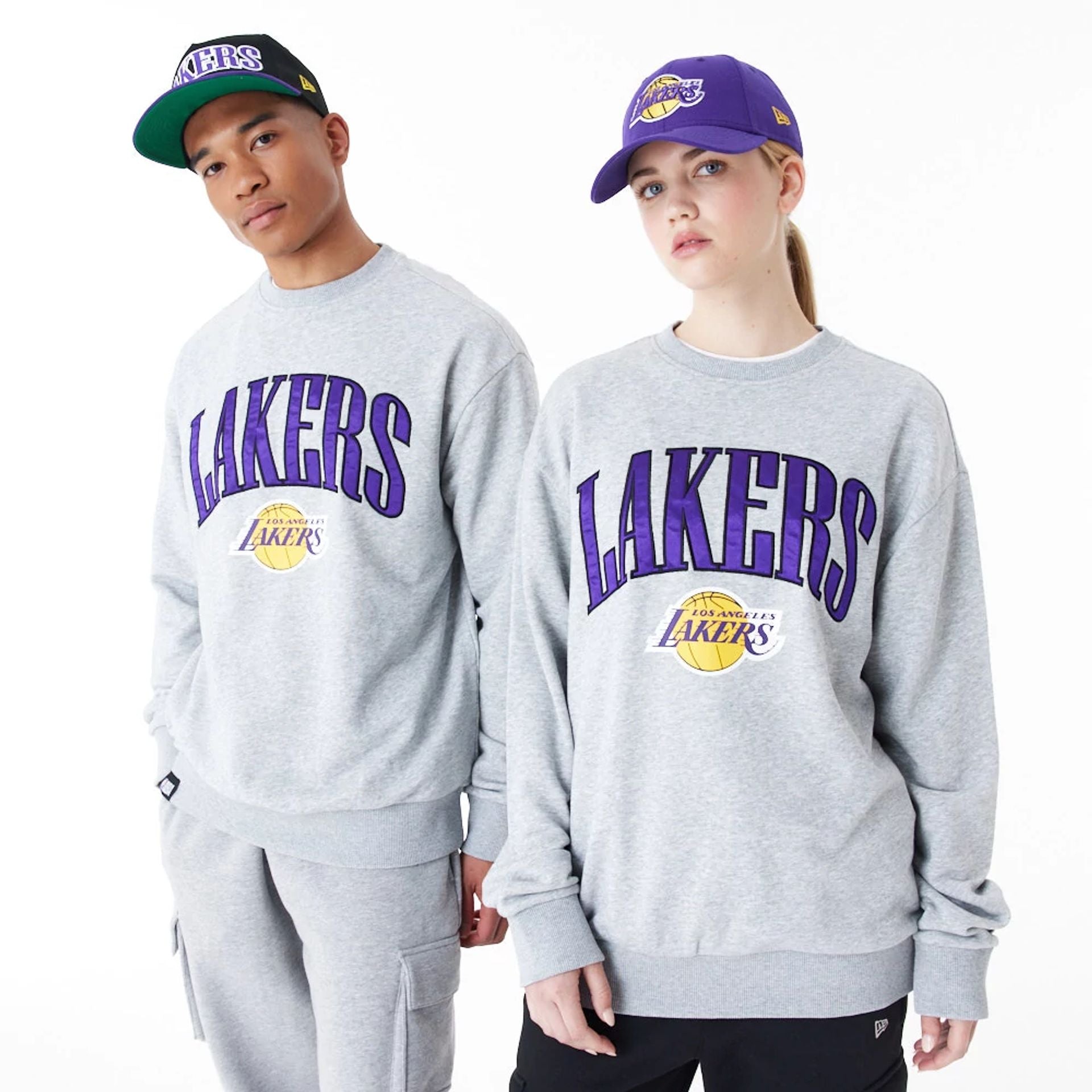 The Male model is wearing LA Lakers NBA Arch Graphic Grey Oversized Crew Neck Sweatshirt 1