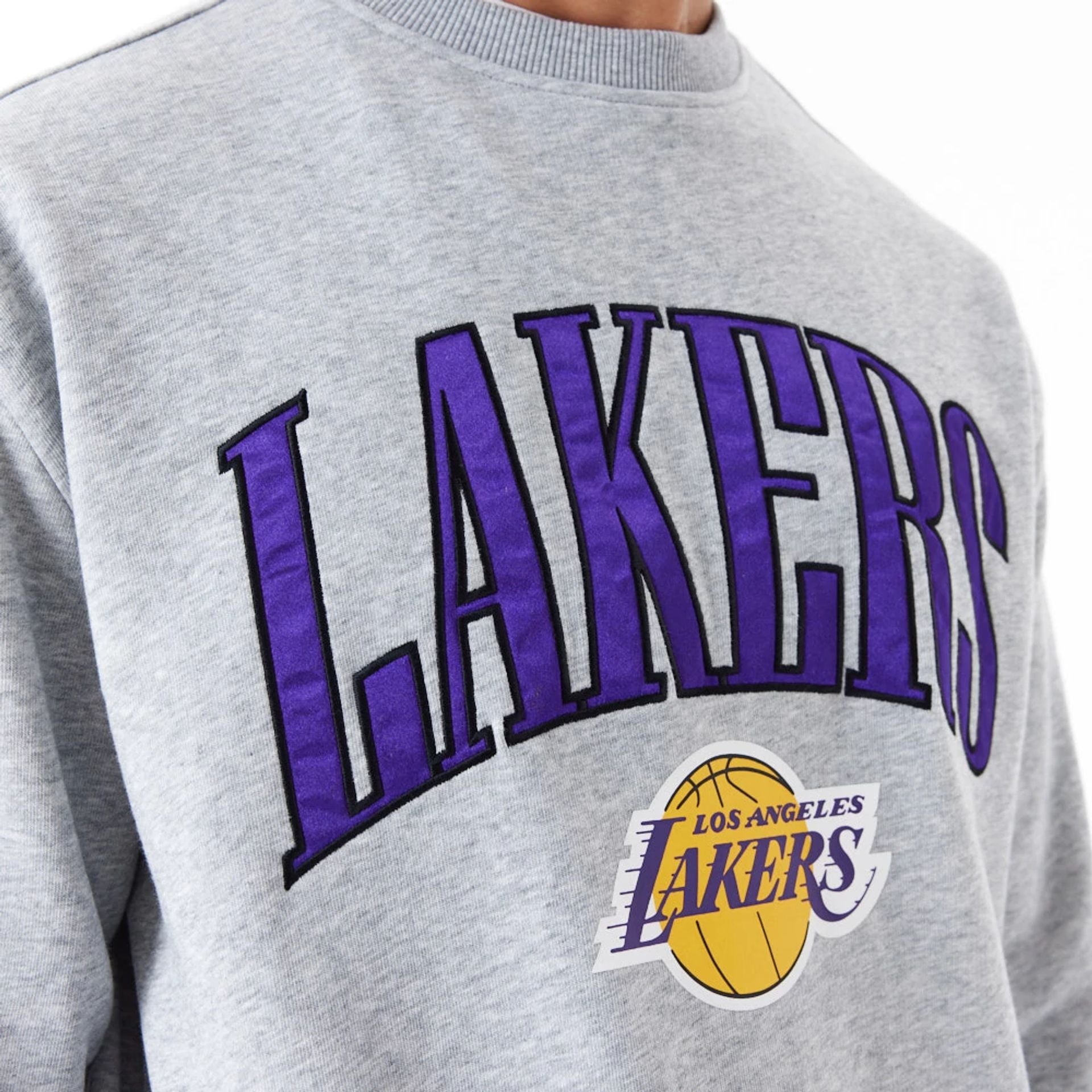 The Male model is wearing LA Lakers NBA Arch Graphic Grey Oversized Crew Neck Sweatshirt 2