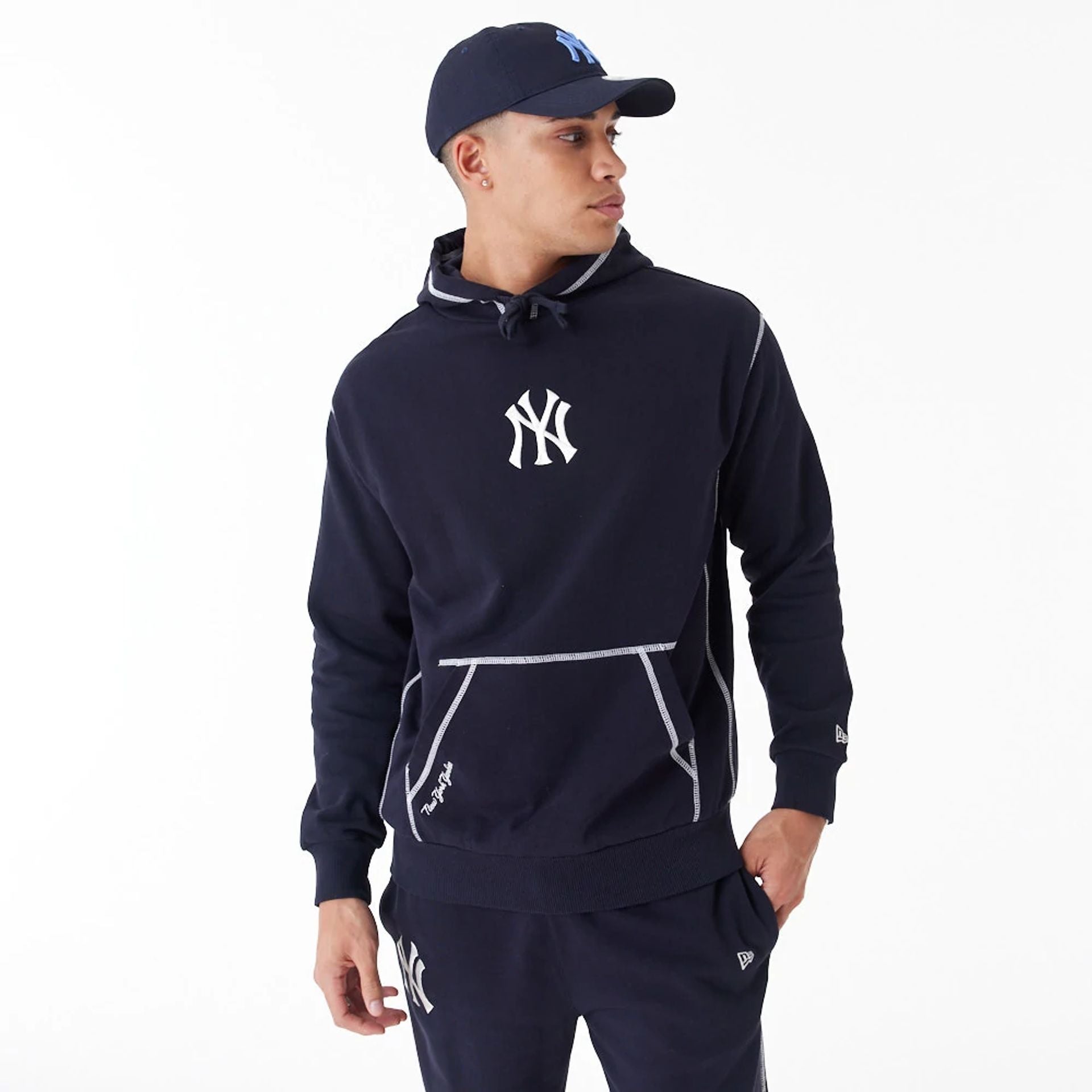 The Male model is wearing New York Yankees MLB World Series Navy Oversized Pullover Hoodie 1