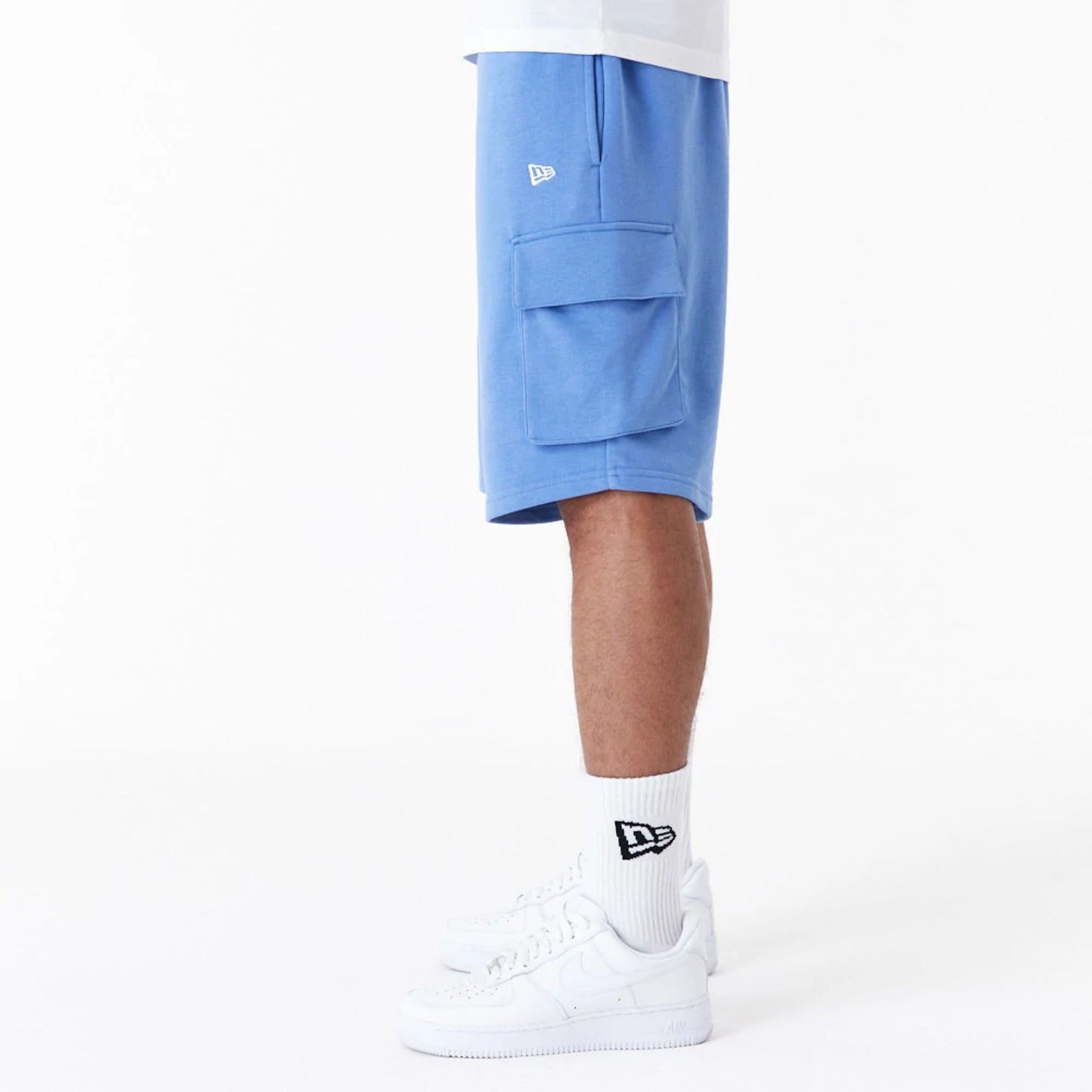 The Male model is wearing New Era Essential Blue Cargo Shorts 5