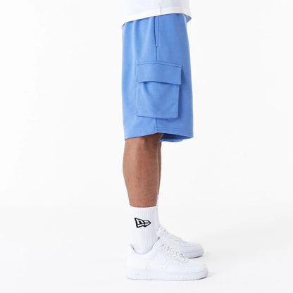 The Male model is wearing New Era Essential Blue Cargo Shorts 6