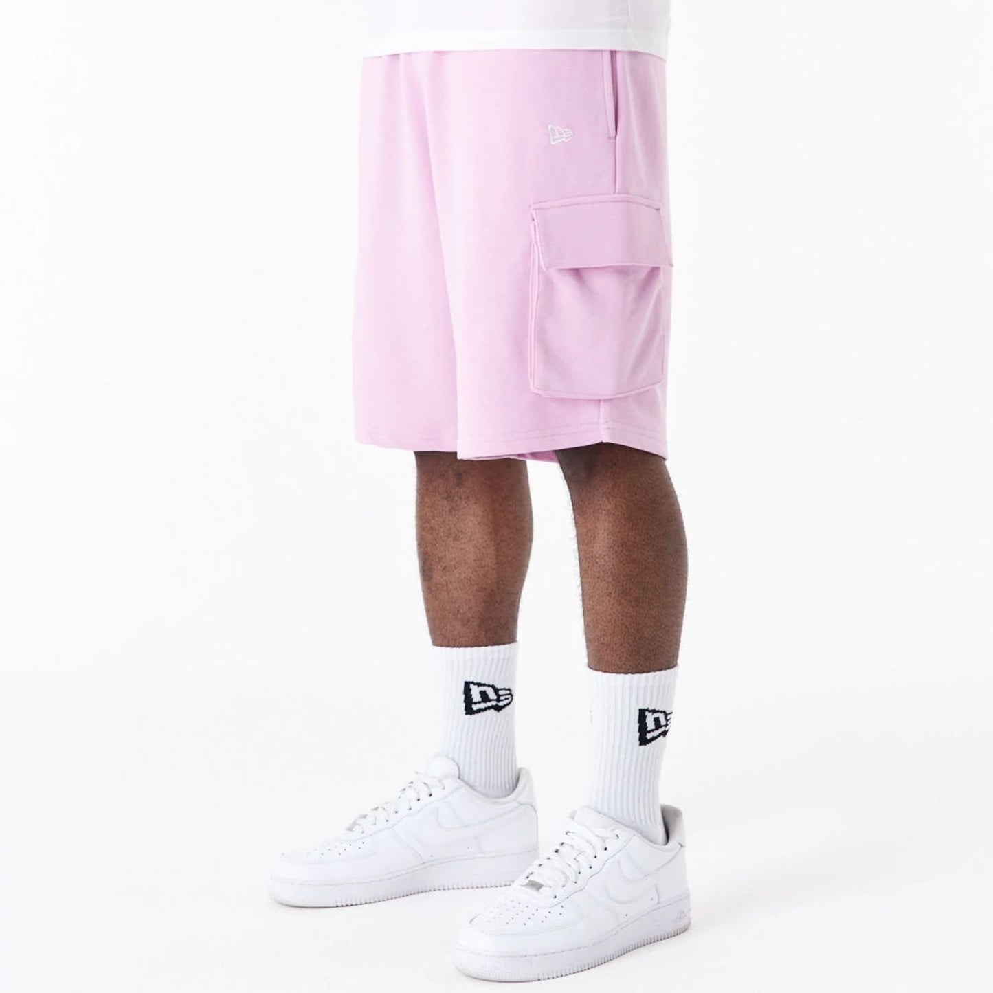 The Male model is wearing New Era Essential Pink Cargo Shorts 2