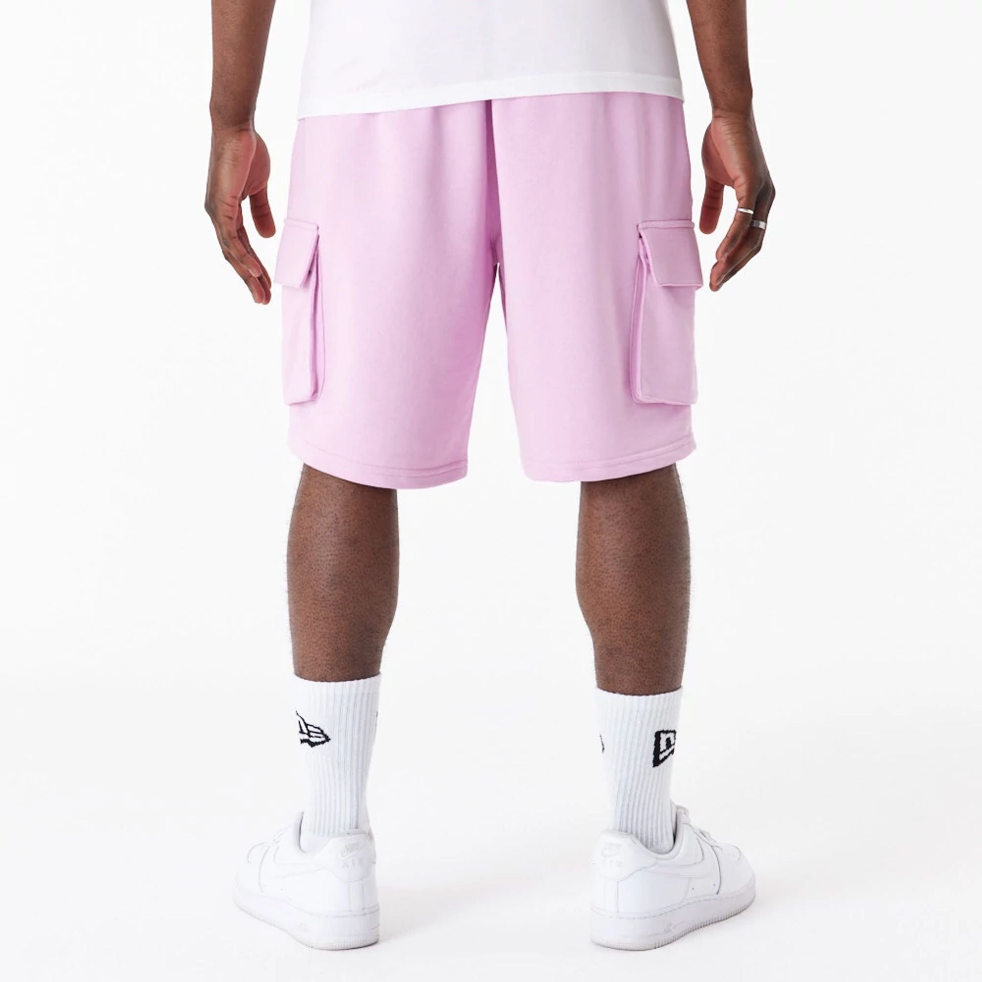 The Male model is wearing New Era Essential Pink Cargo Shorts 8