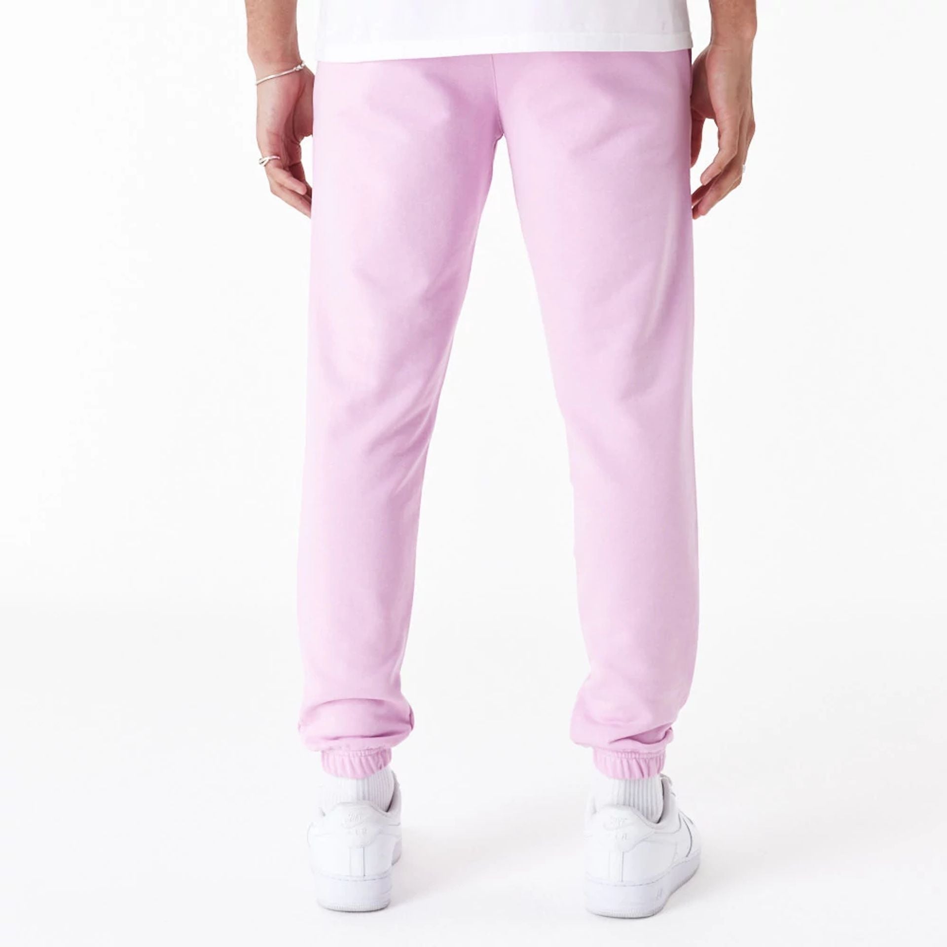 The Male model is wearing New Era Essential Pink Slim Joggers 2