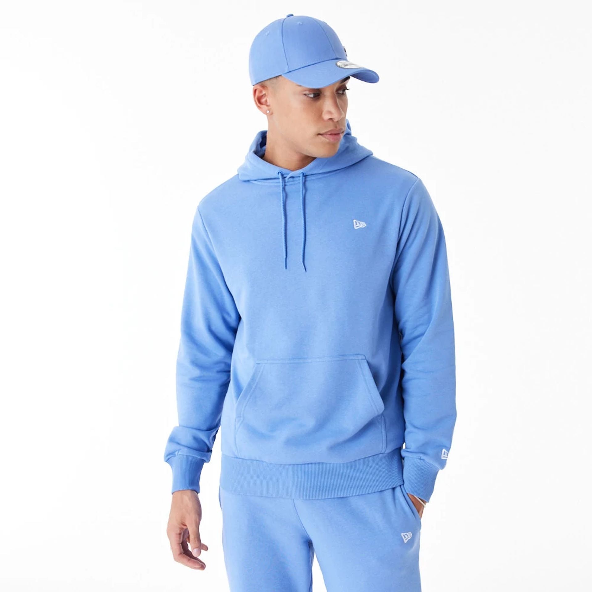 The Male model is wearing New Era Essential Blue Pullover Hoodie 2