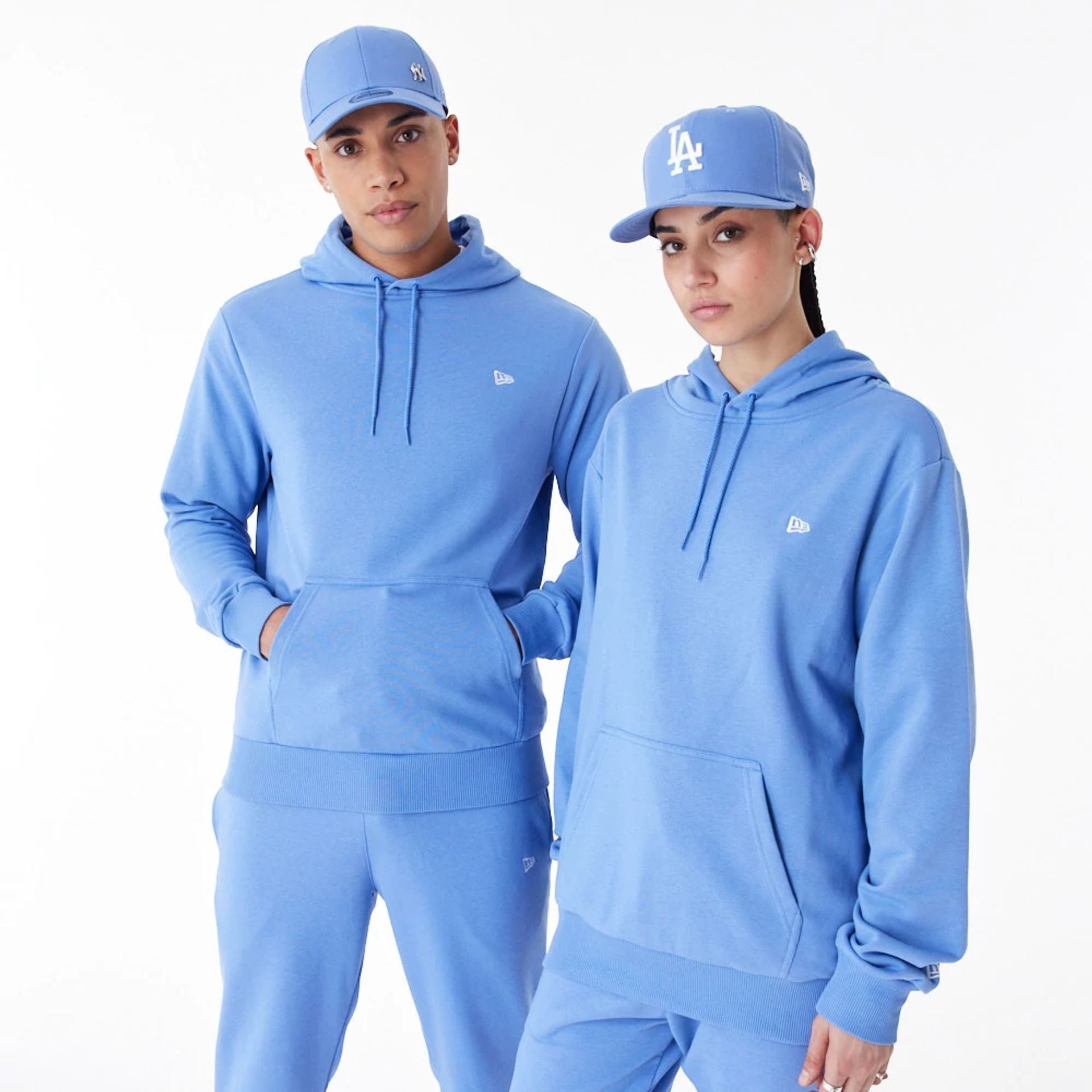 The Male model is wearing New Era Essential Blue Pullover Hoodie 1