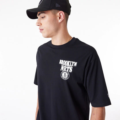 The Male model is wearing Brooklyn Nets NBA Script Black Oversized T-Shirt 3