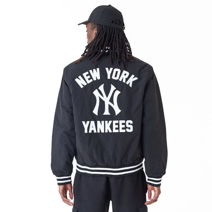 The Male model is wearing New York Yankees MLB Team Wordmark Black Bomber Jacket 5