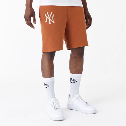 The Male model is wearing New York Yankees League Essential Brown Shorts 2