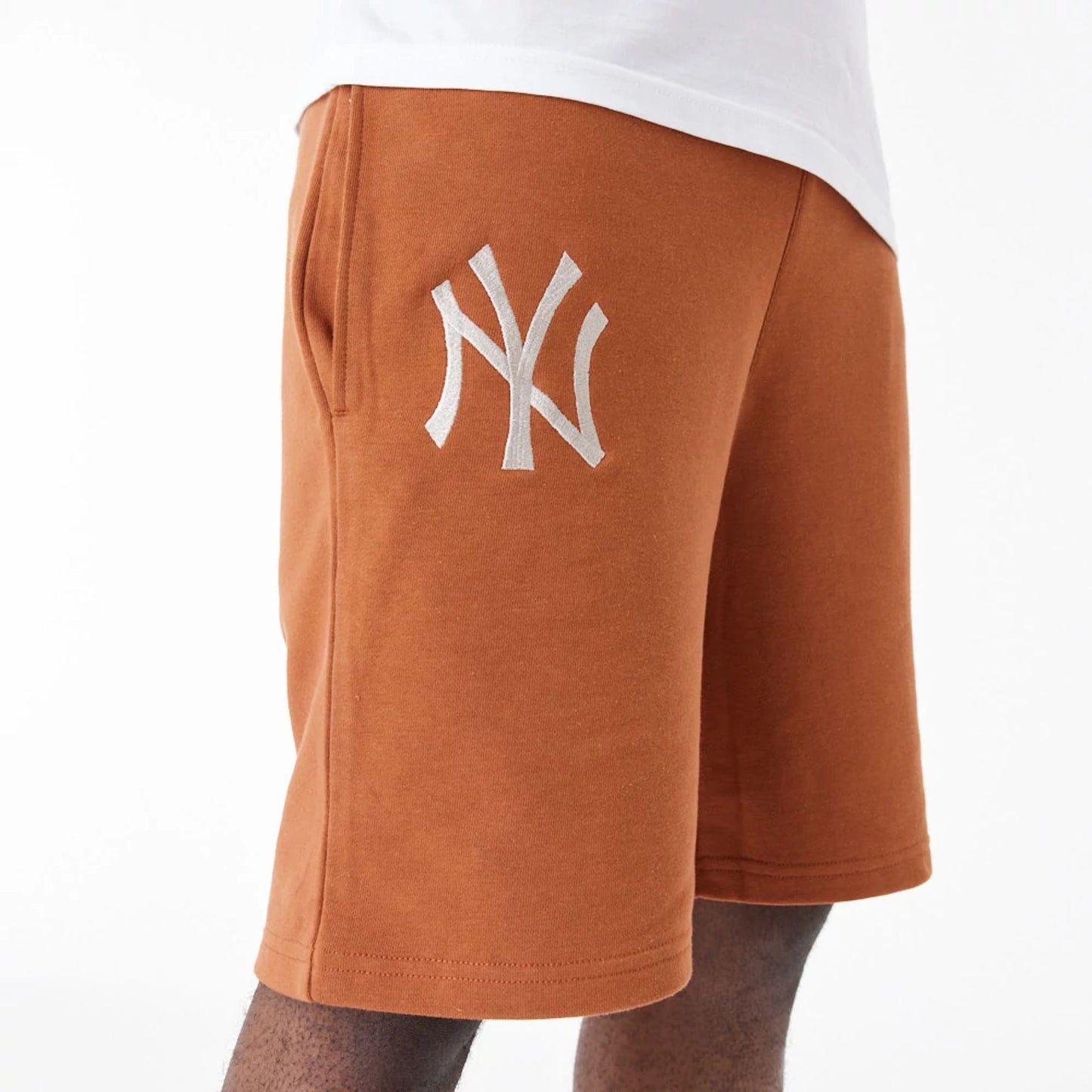 The Male model is wearing New York Yankees League Essential Brown Shorts 5