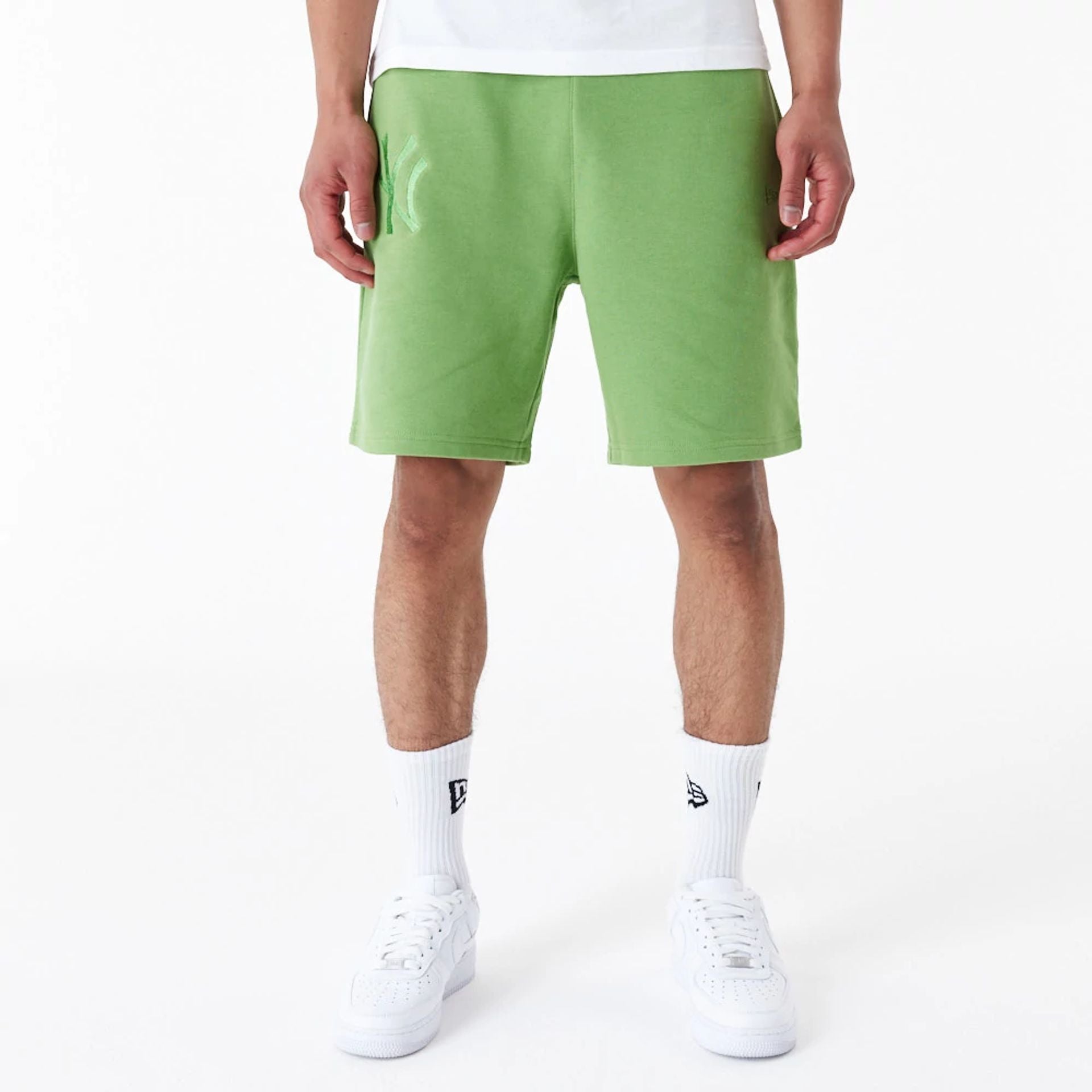 The Male model is wearing New York Yankees League Essential Green Shorts 1