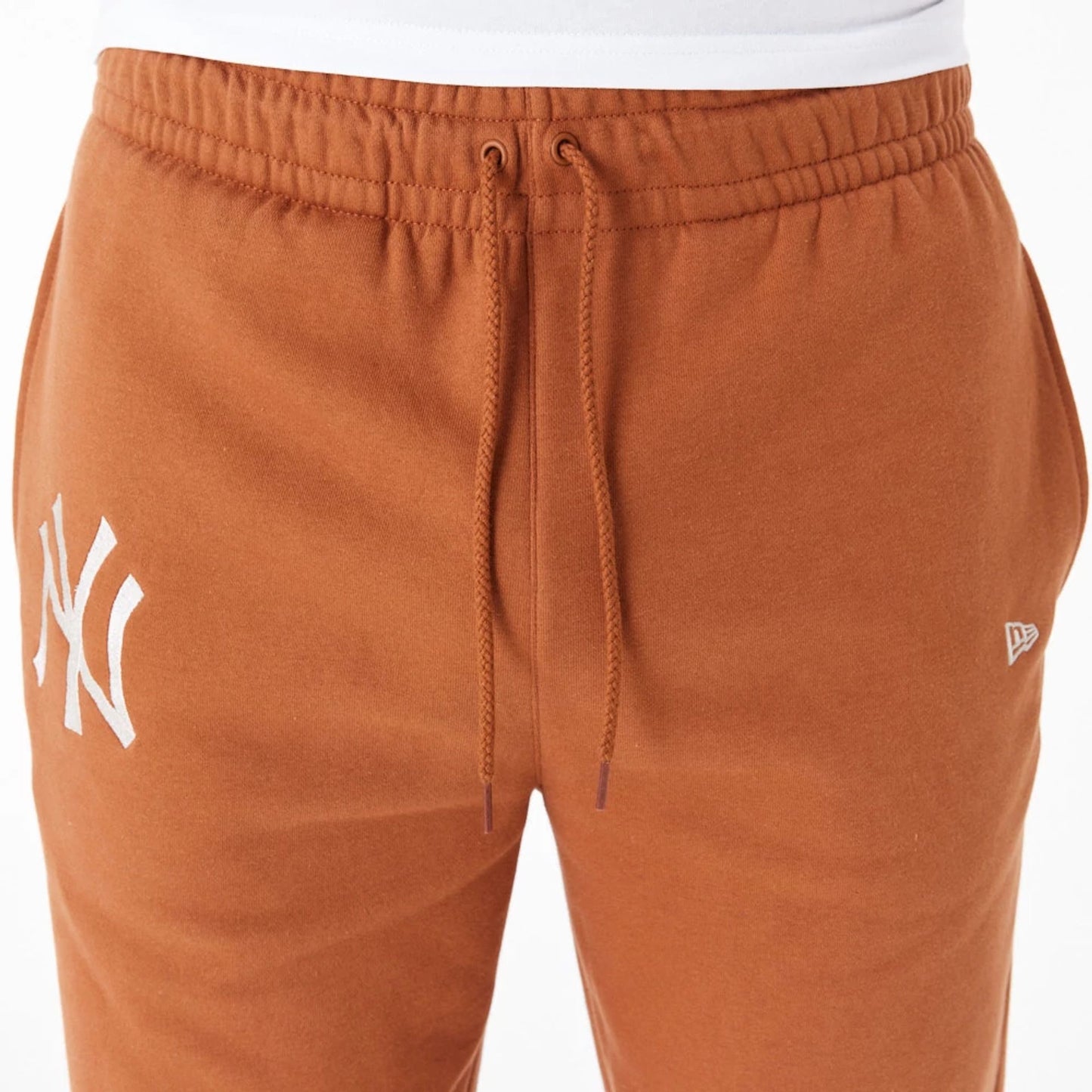 The Male model is wearing New York Yankees League Essential Brown Joggers 2