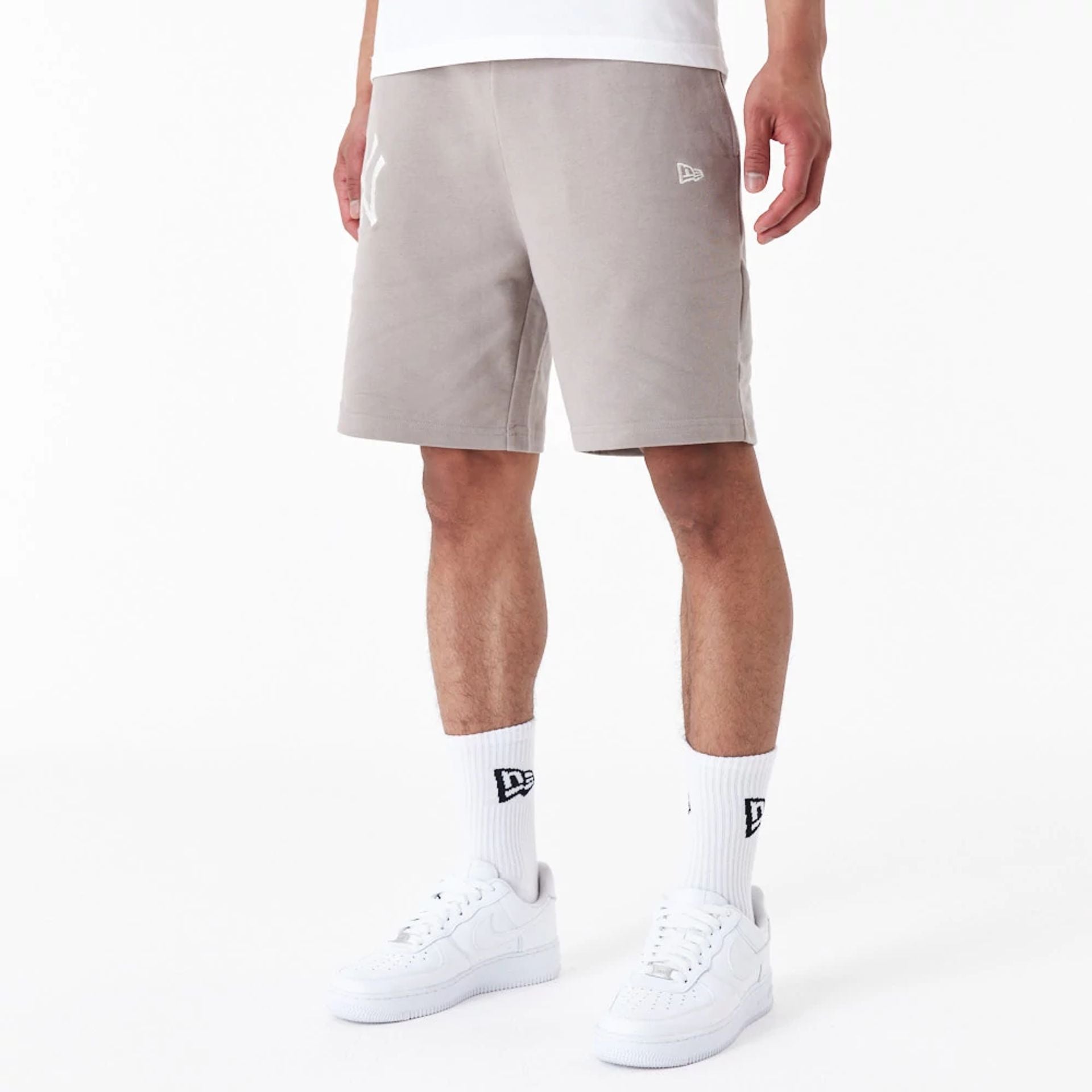 The Male model is wearing New York Yankees League Essential Beige Shorts 5