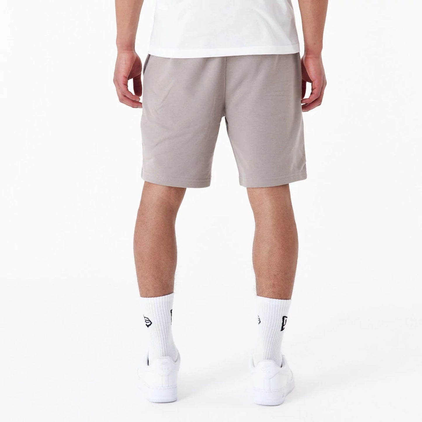 The Male model is wearing New York Yankees League Essential Beige Shorts 4