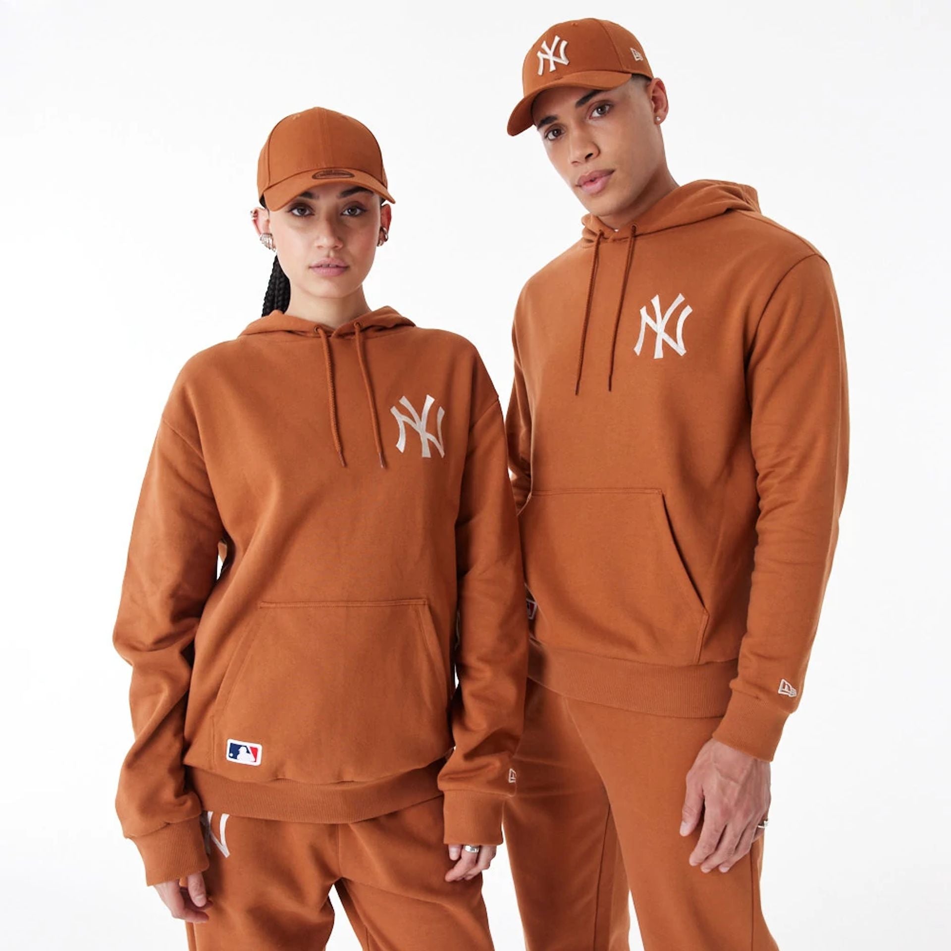 The Male model is wearing New York Yankees League Essential Brown Oversized Pullover Hoodie 1