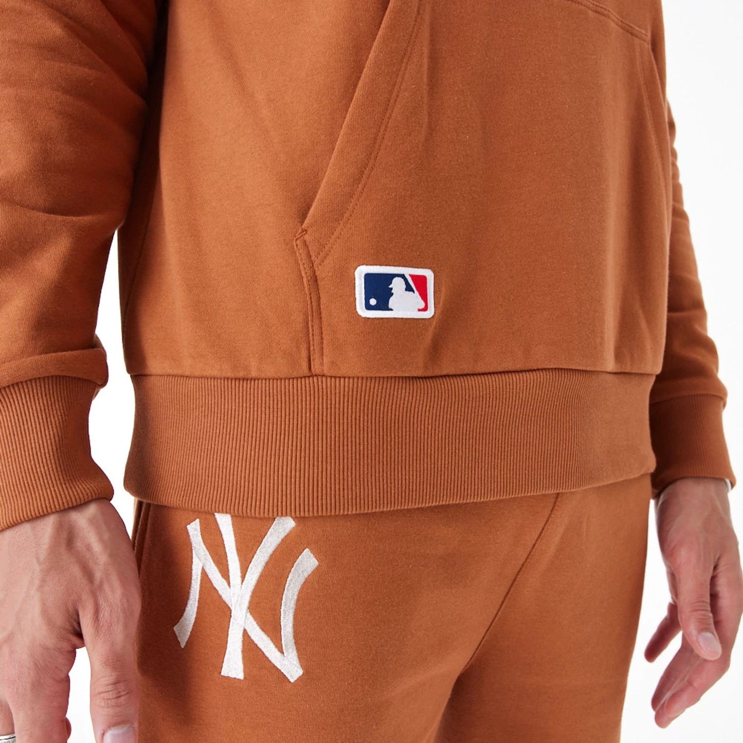 The Male model is wearing New York Yankees League Essential Brown Oversized Pullover Hoodie 8