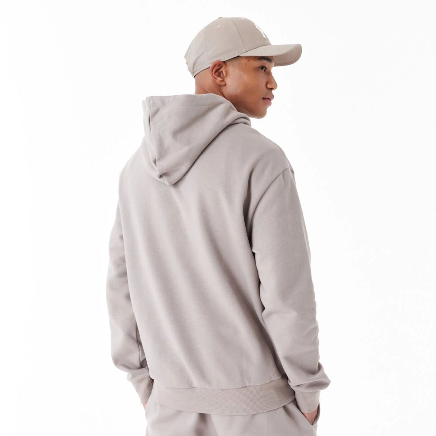 The Male model is wearing New York Yankees League Essential Beige Oversized Pullover Hoodie 5