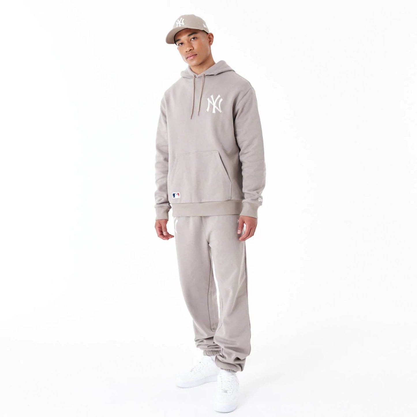 The Male model is wearing New York Yankees League Essential Beige Oversized Pullover Hoodie 3